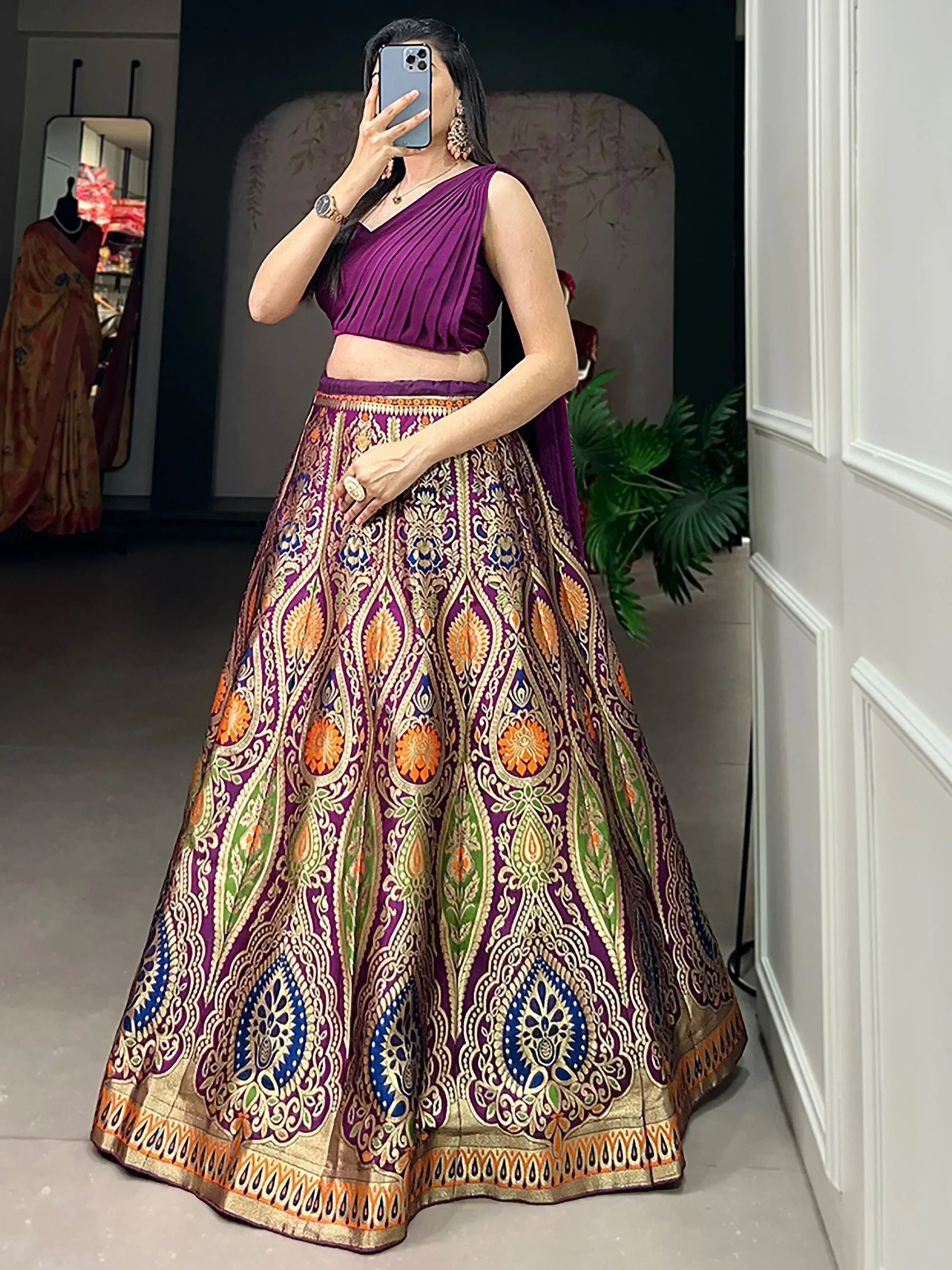 Purple designer lehenga choli with intricate gold and multicolor embroidery, perfect for Indian ethnic wear.