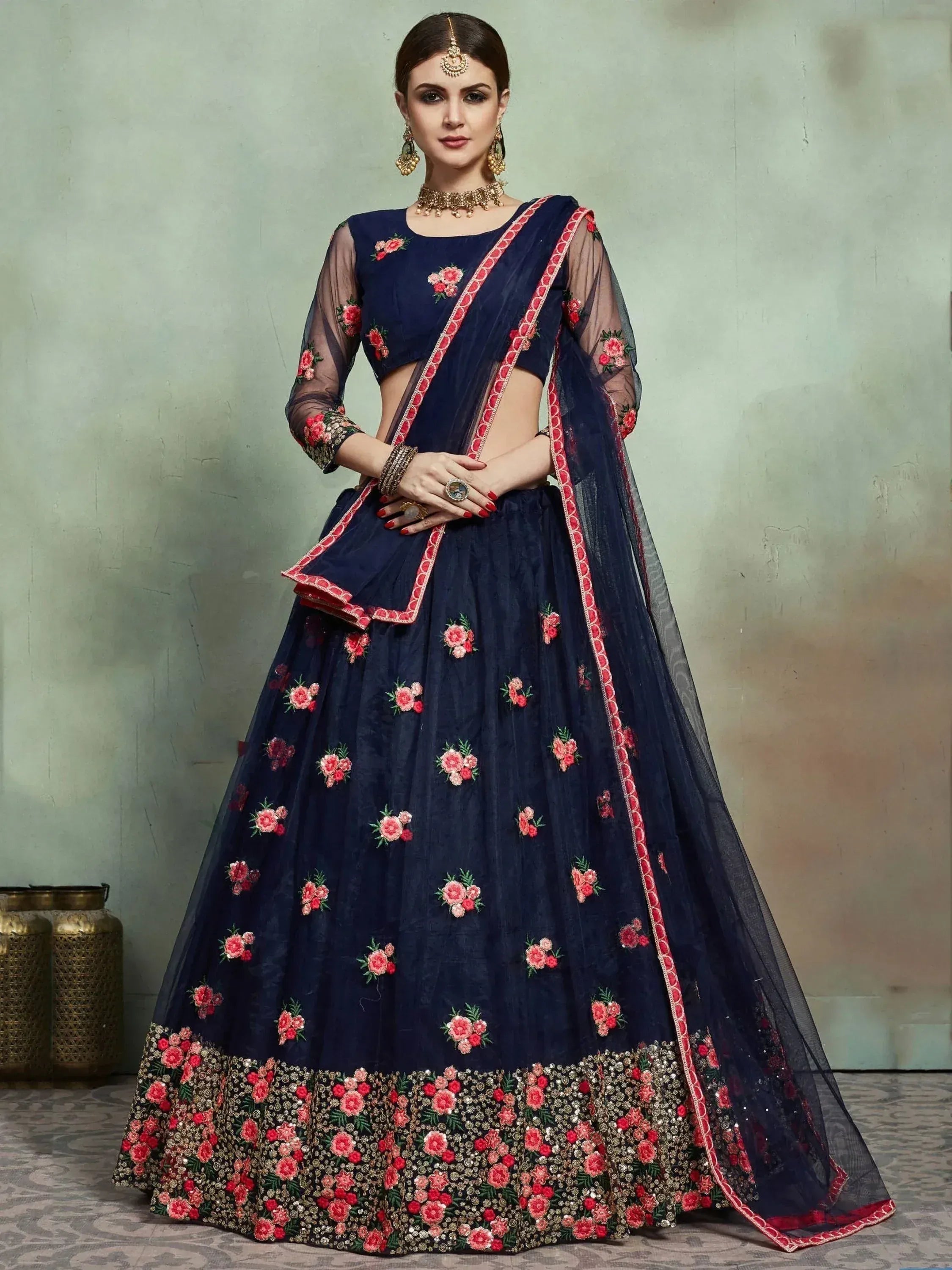 Navy blue lehenga choli with pink floral embroidery and sheer sleeves, perfect for Indian ethnic occasions