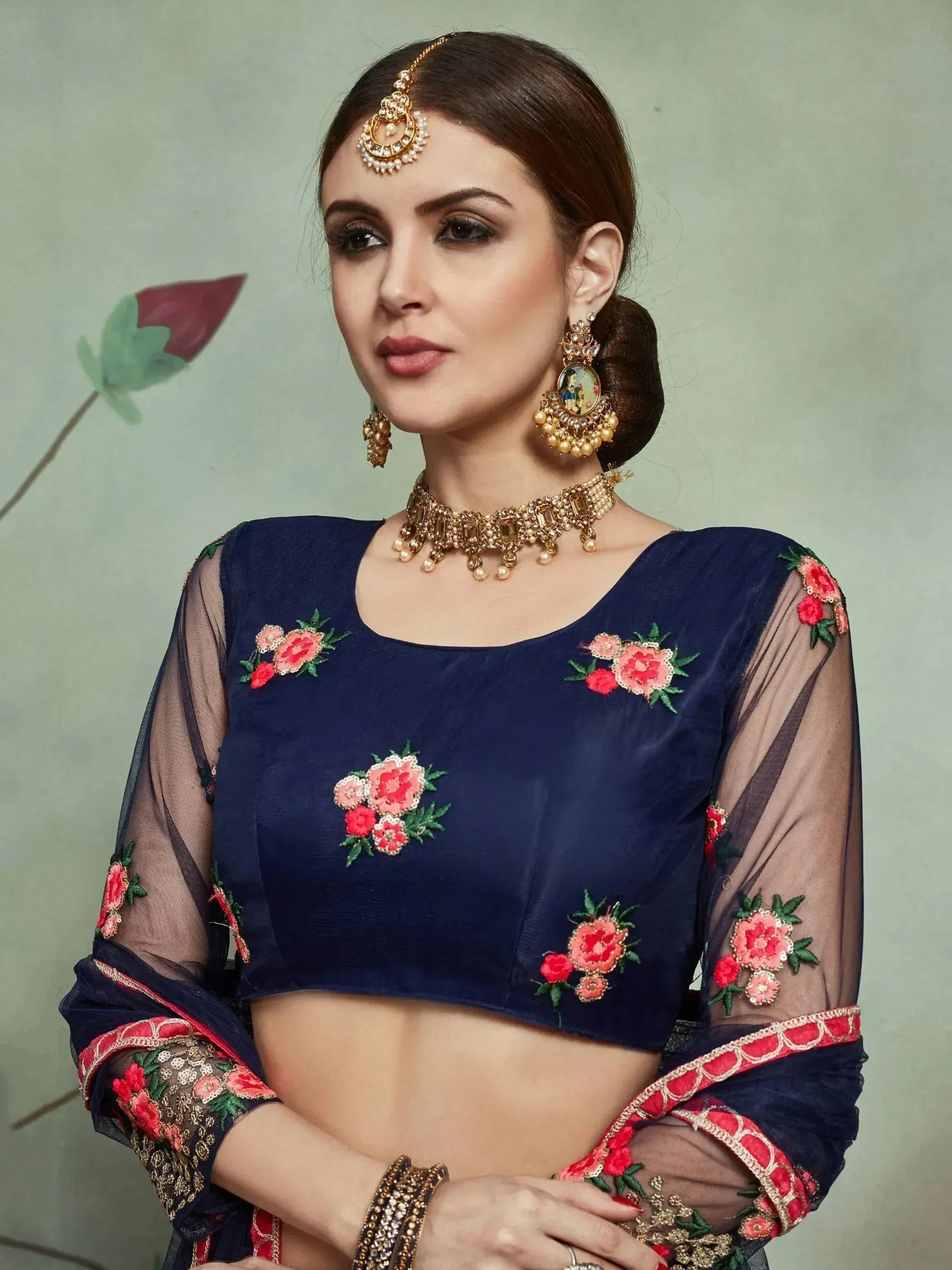 Navy blue embroidered crop top with floral detailing, sheer sleeves, and traditional Indian jewelry for ethnic wear