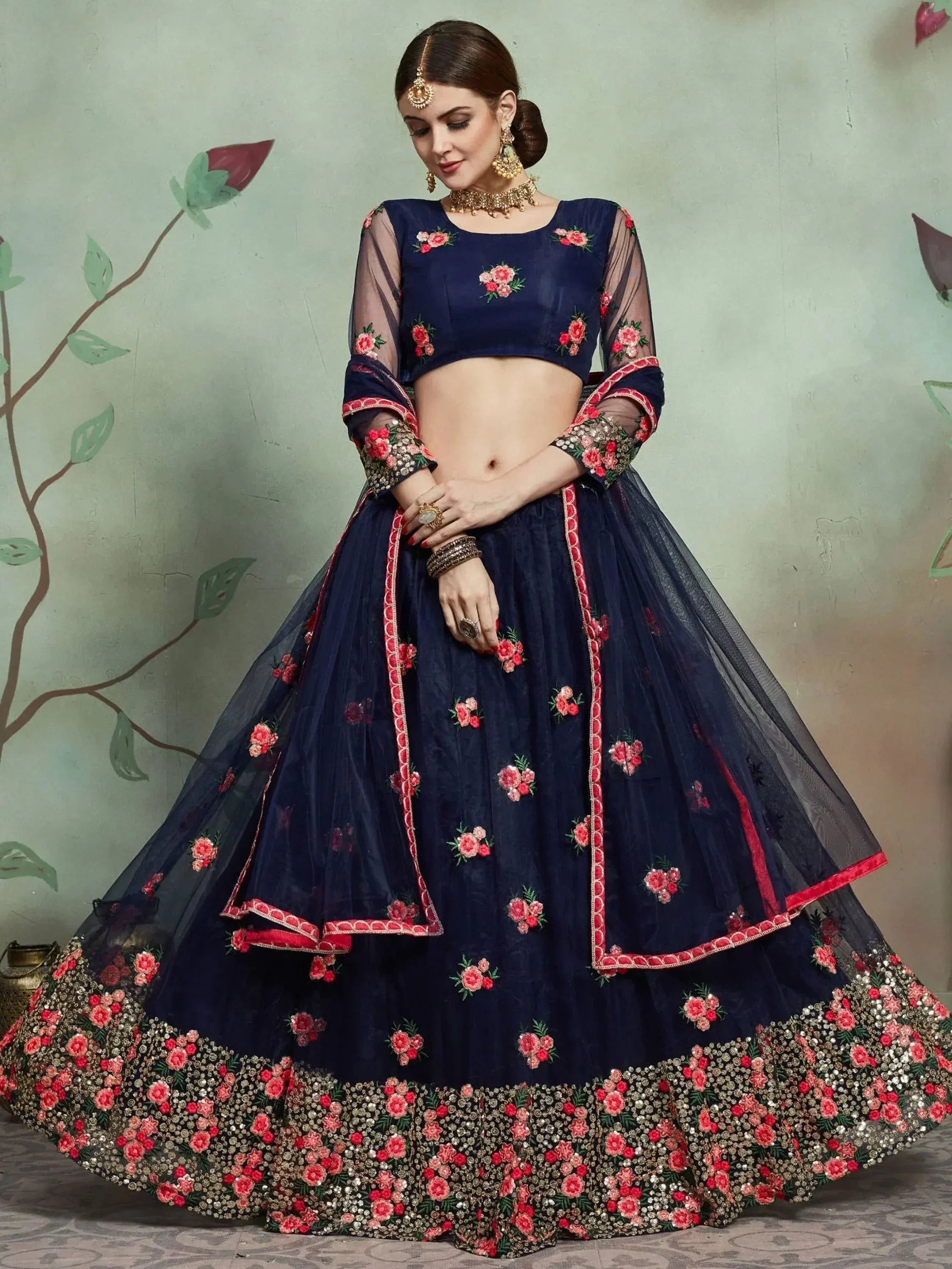 Navy blue lehenga choli with floral embroidery and sheer sleeves, perfect for Indian ethnic wear events.