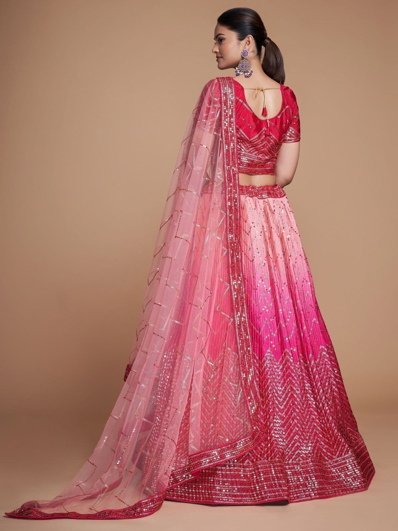 Pink and red sequined lehenga choli with sheer dupatta, perfect for Indian weddings and festive occasions.