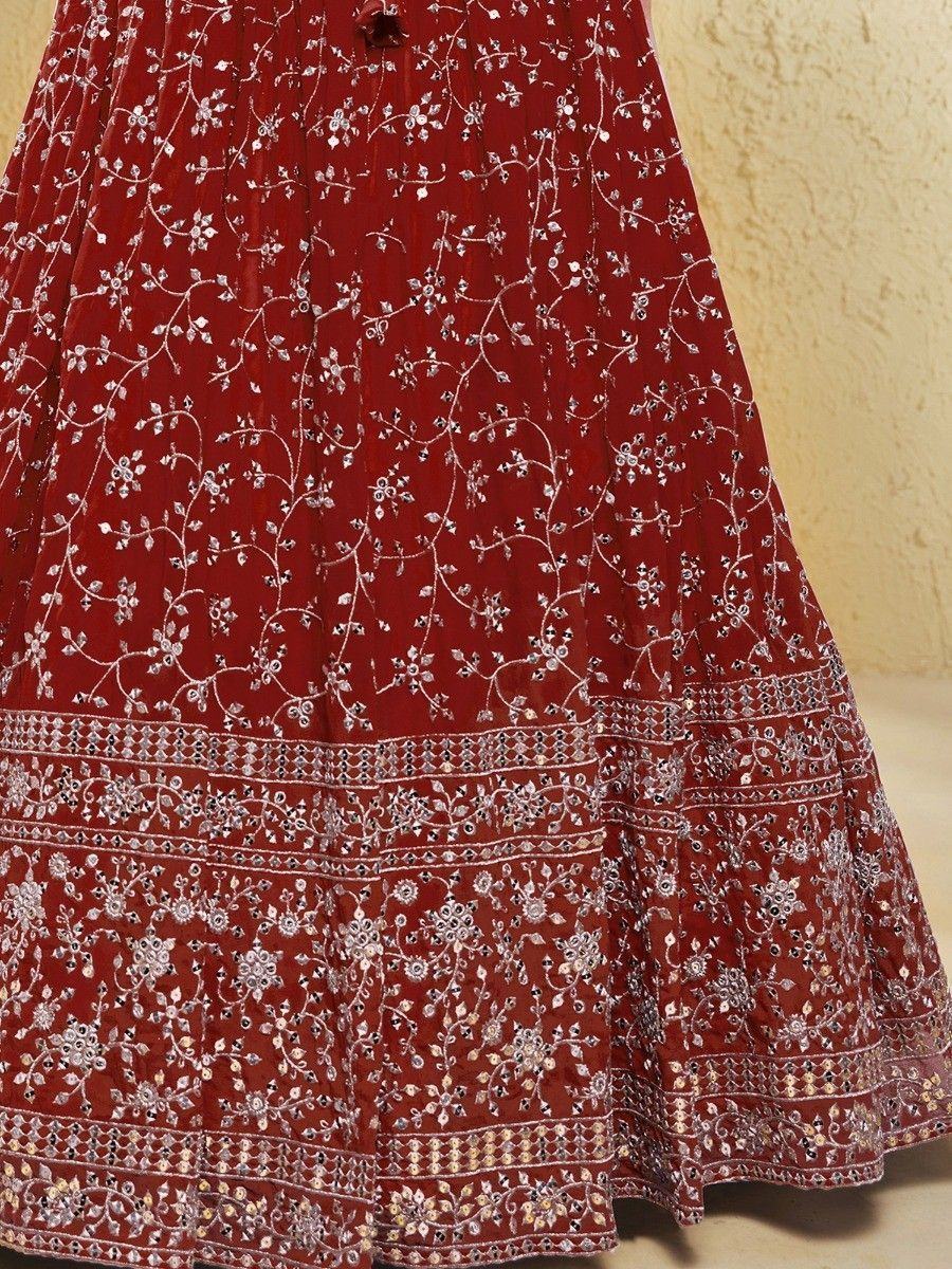Red embroidered lehenga with intricate silver floral work and mirror detailing, perfect for Indian ethnic wear.