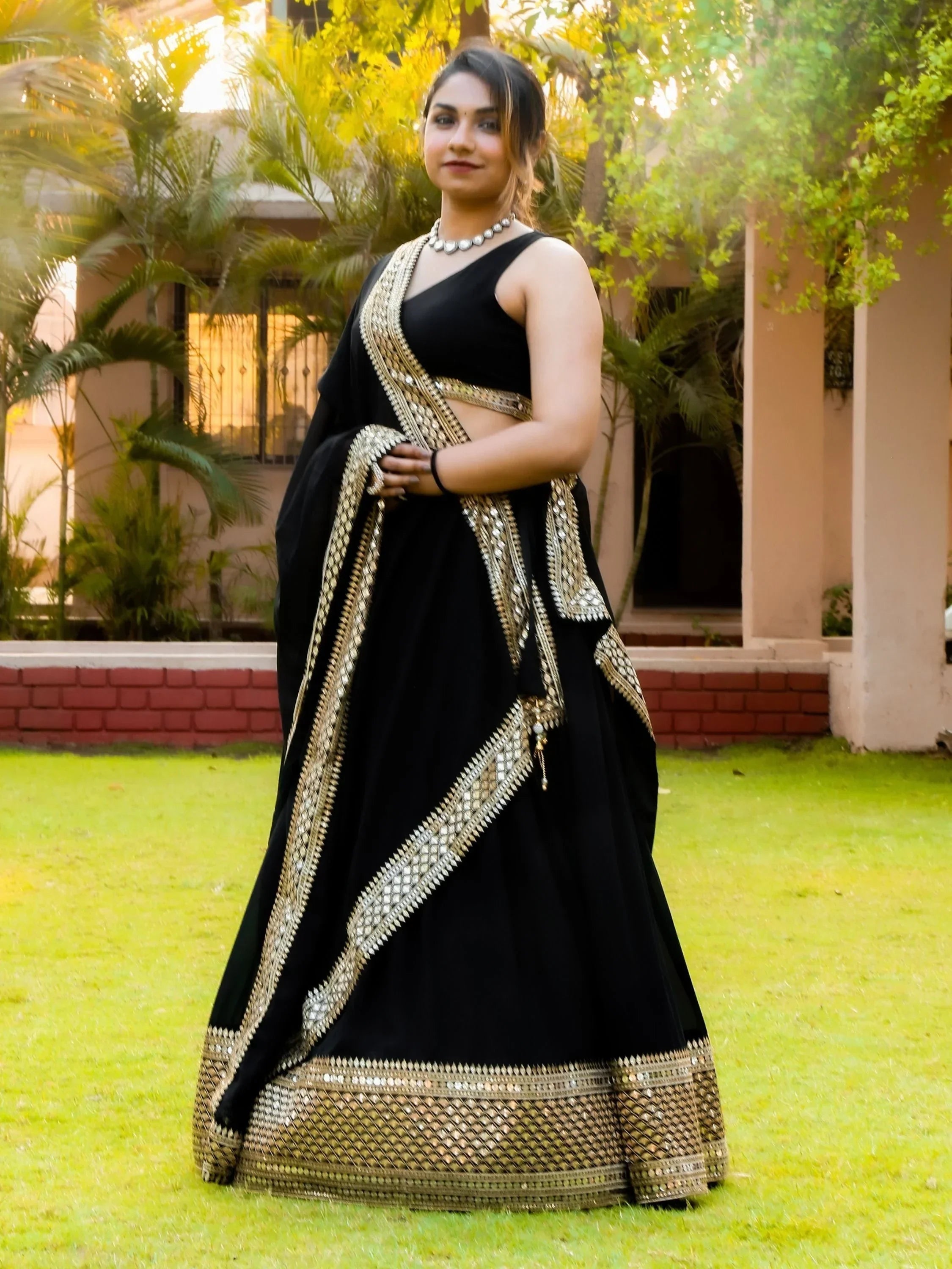 Black lehenga choli with gold mirror work, perfect for Indian ethnic wear and festive occasions.