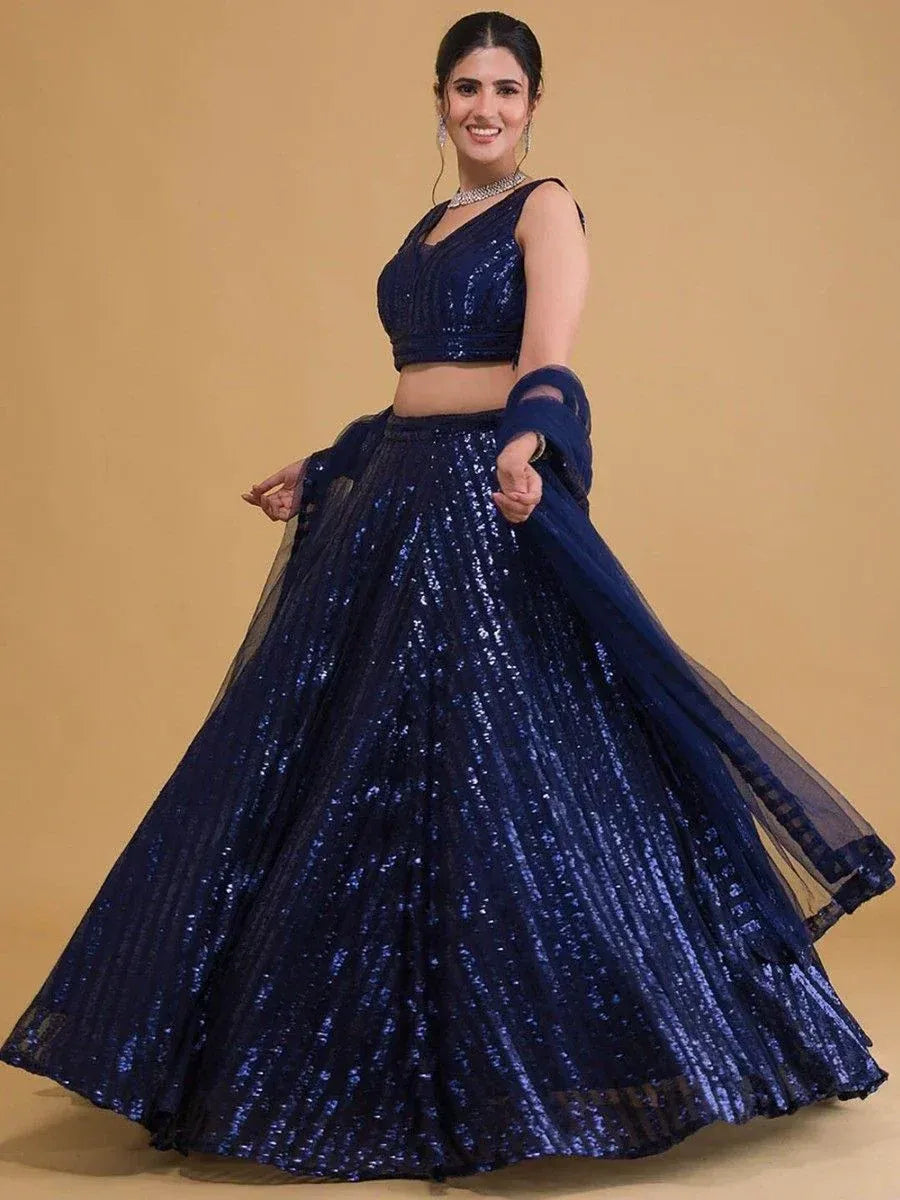 Navy blue sequin lehenga choli with sheer dupatta, perfect for Indian ethnic events and weddings.