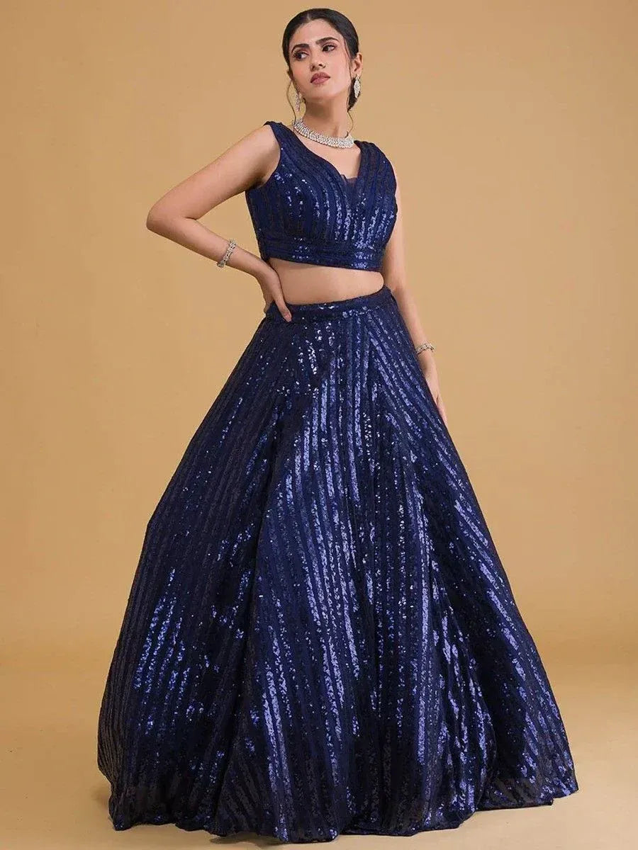 Navy blue sequin lehenga choli with sleeveless crop top and flared skirt, perfect for weddings and parties