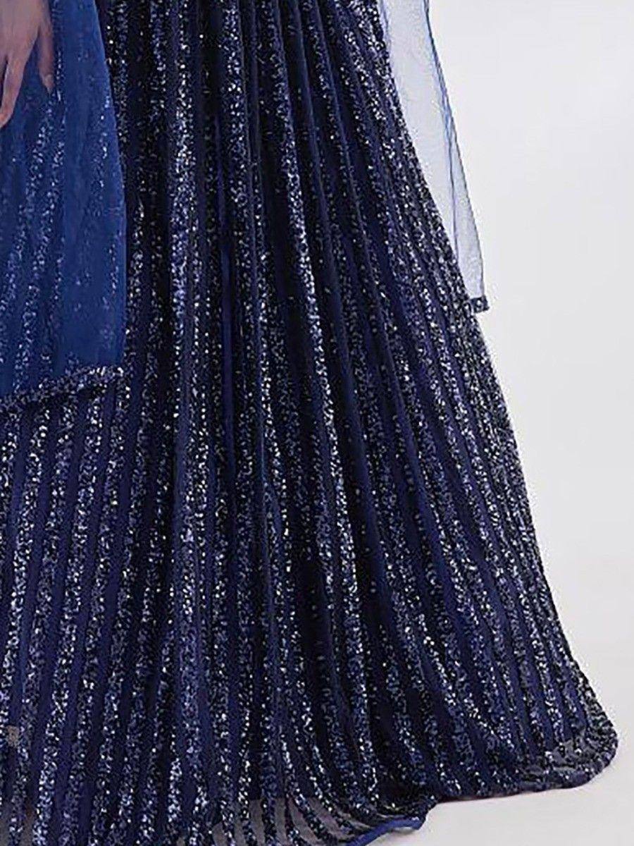Navy blue pleated lehenga with shimmering sequins and sheer dupatta, perfect for Indian ethnic wear occasions