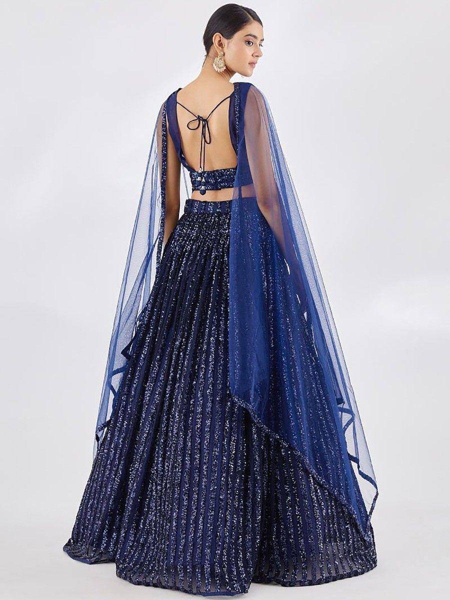 Navy blue sequined lehenga choli with sheer cape and back tie detail, perfect for Indian ethnic occasions