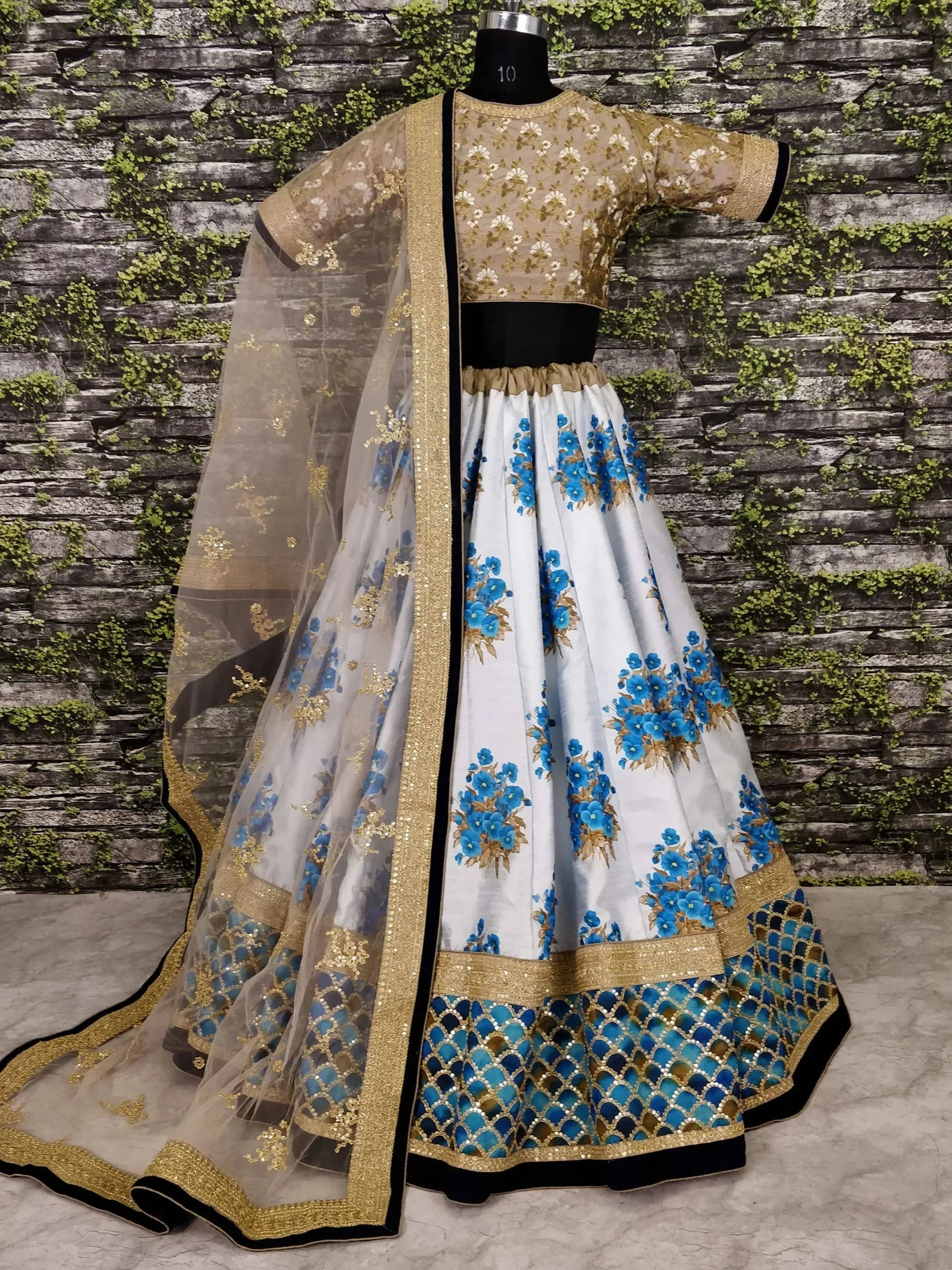 White and blue floral lehenga choli with gold embroidery and sheer dupatta, ethnic Indian wear