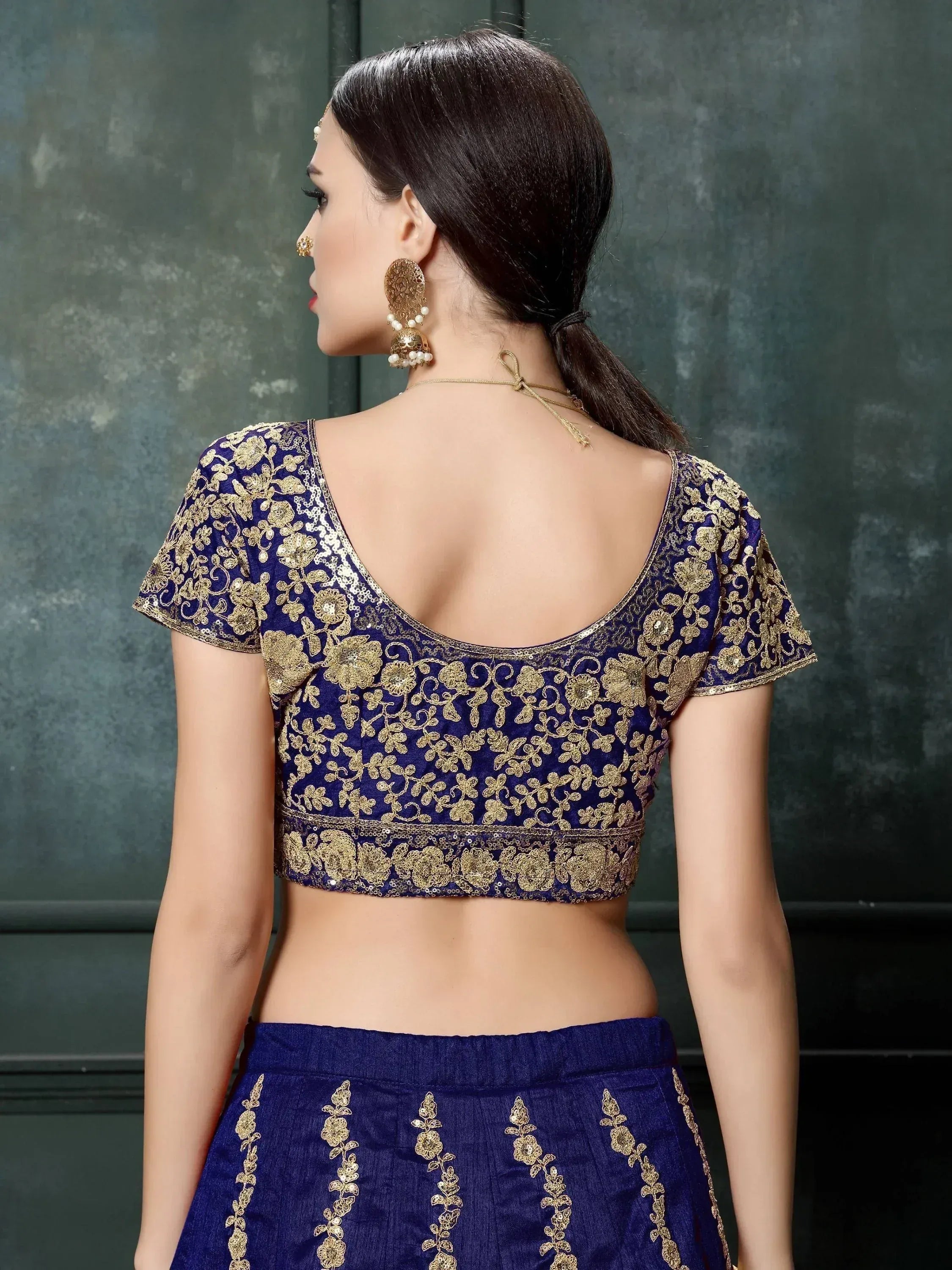 Blue and gold embroidered lehenga choli with floral detailing, back view