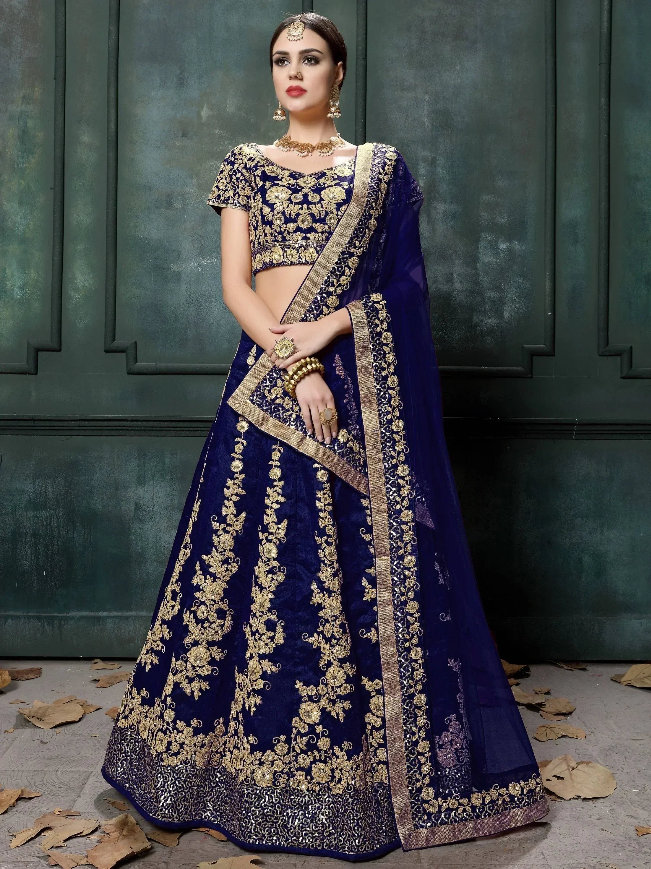 Royal blue lehenga choli with gold embroidery, perfect for Indian weddings and festive occasions.