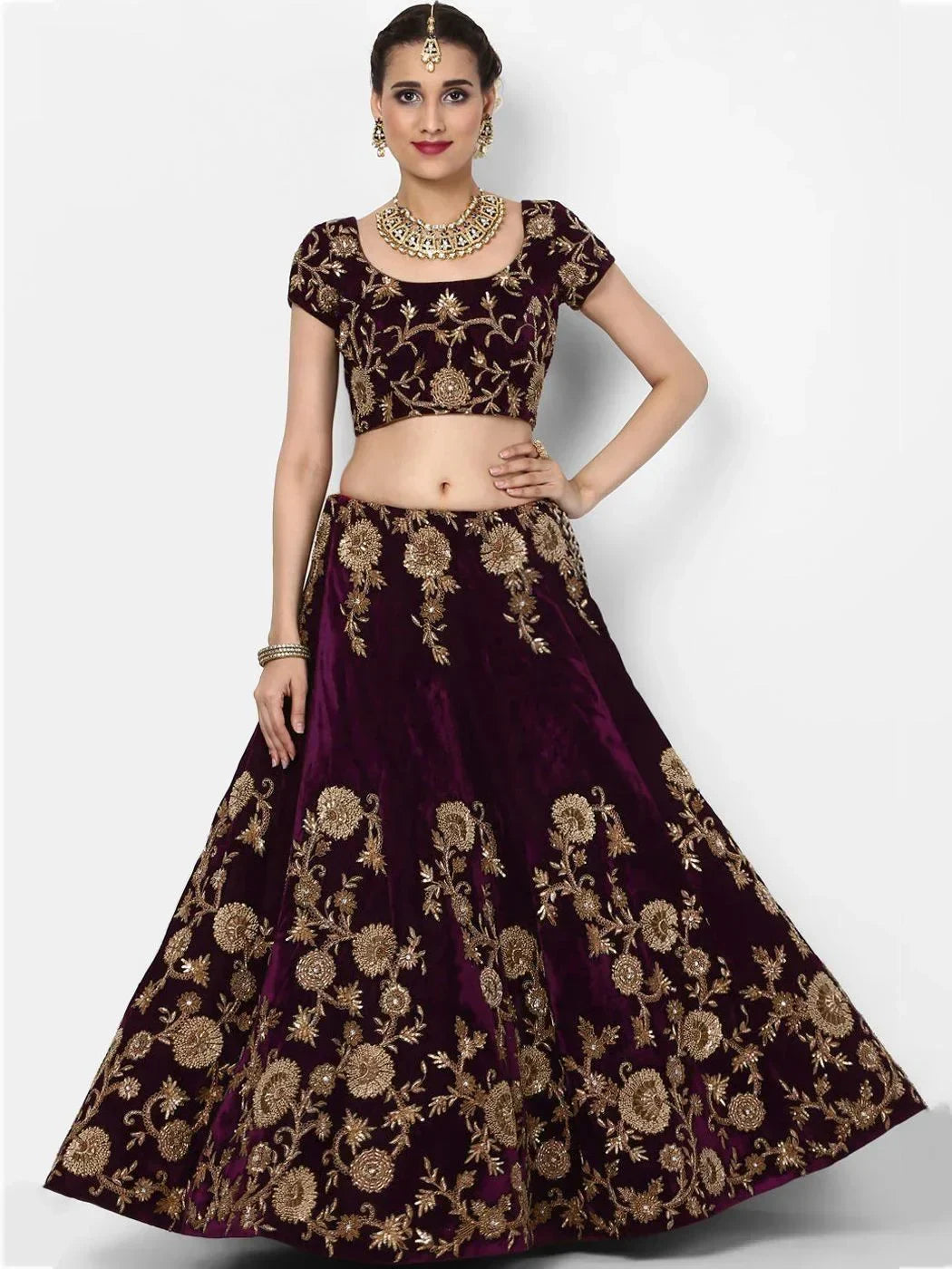 Burgundy velvet lehenga choli with gold floral embroidery, perfect for Indian weddings and festive occasions.