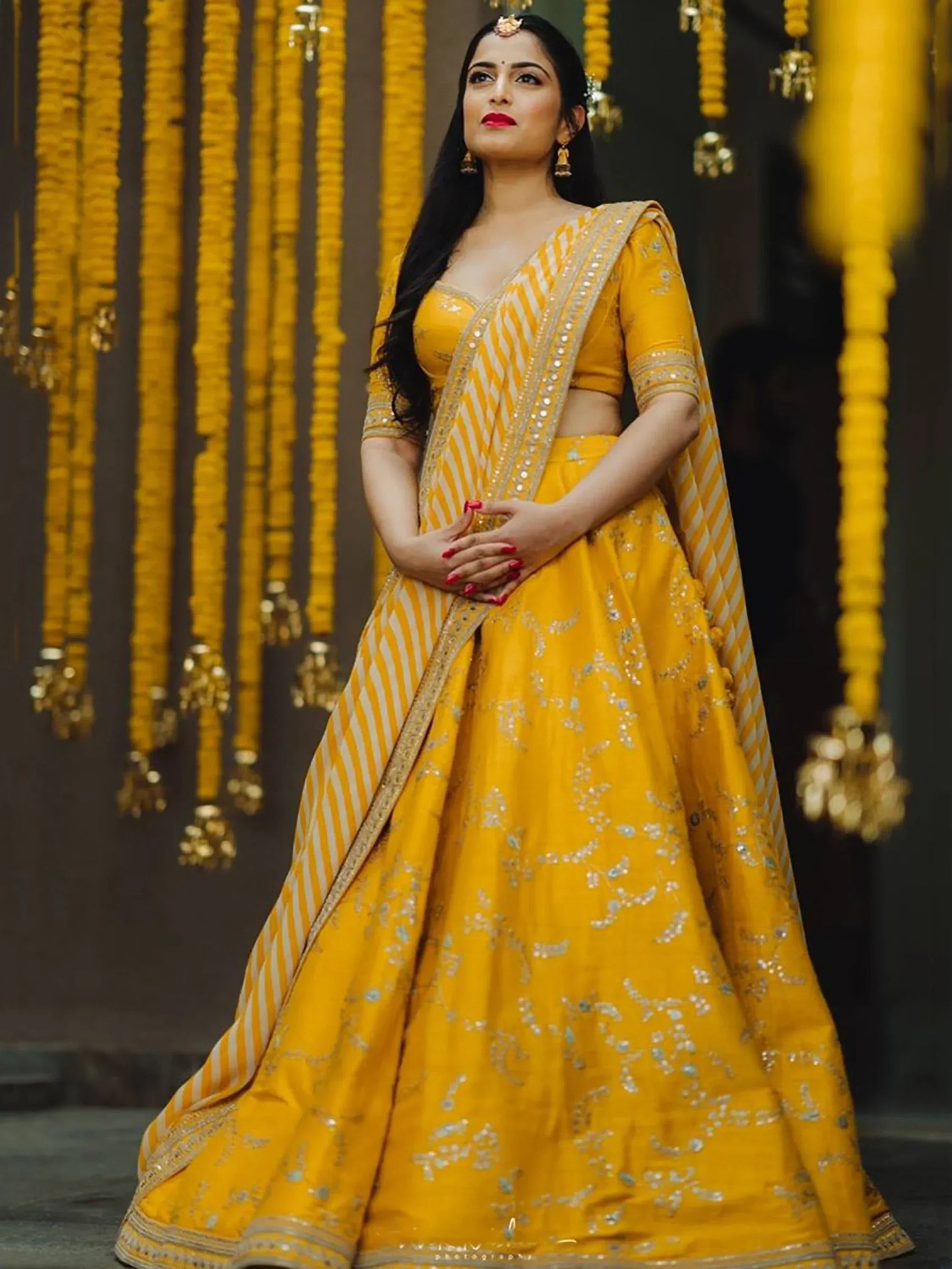 Yellow designer lehenga choli with gold embroidery, perfect for Indian weddings and festive occasions.
