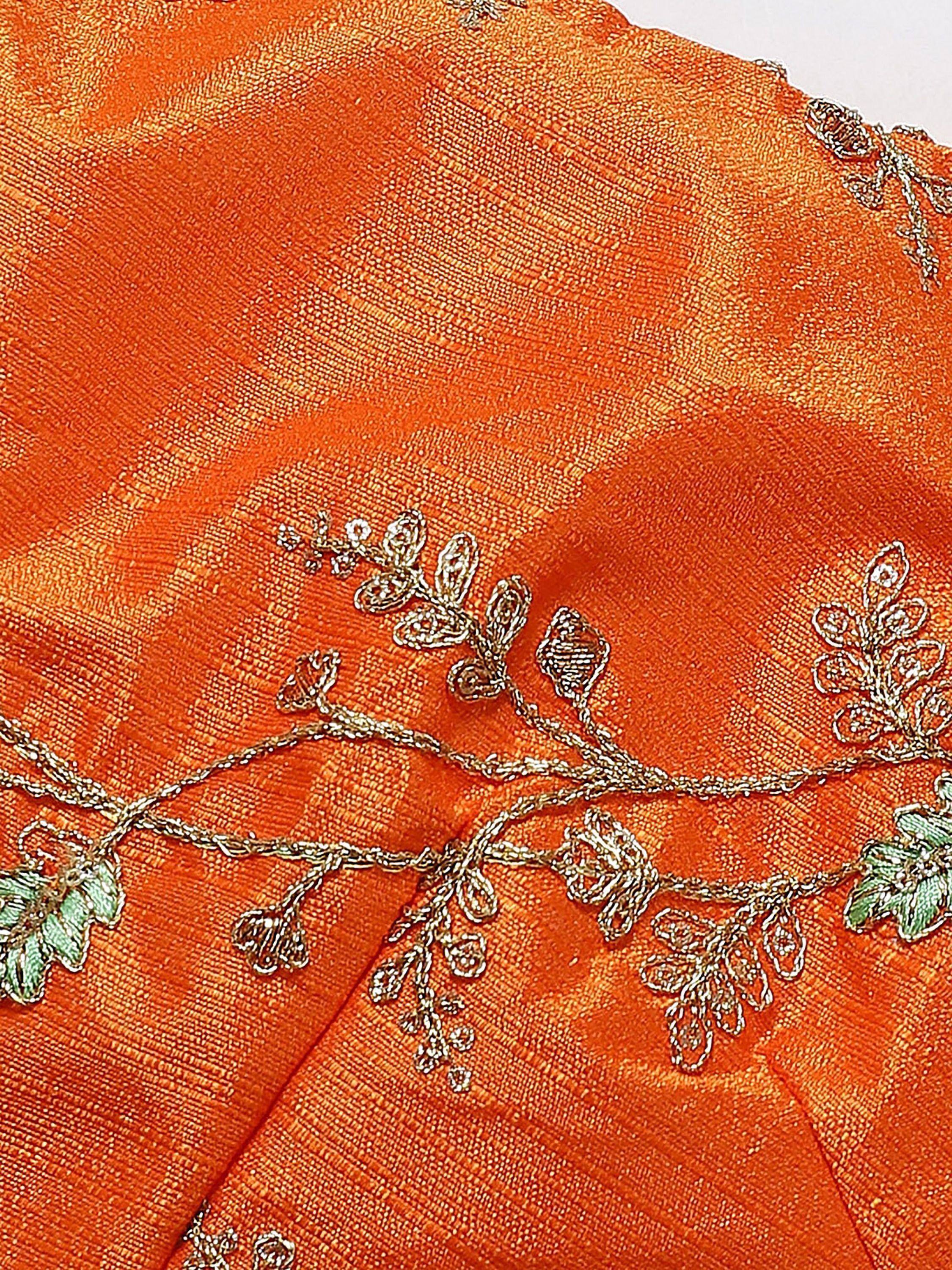 Orange ethnic wear with gold floral embroidery and green leaves, perfect for Indian occasions.