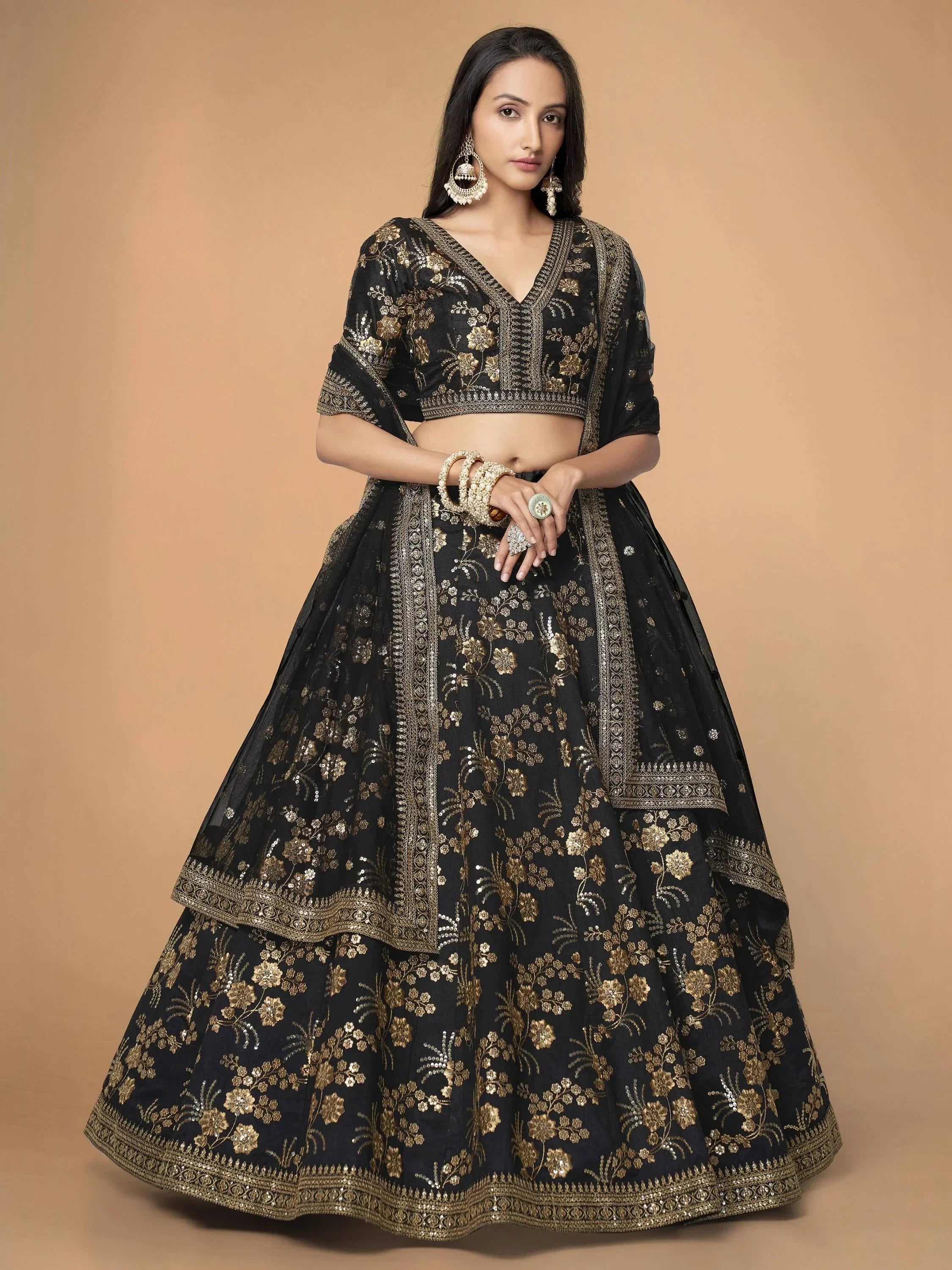 Black and gold embroidered lehenga choli with floral motifs, perfect for Indian ethnic wear occasions