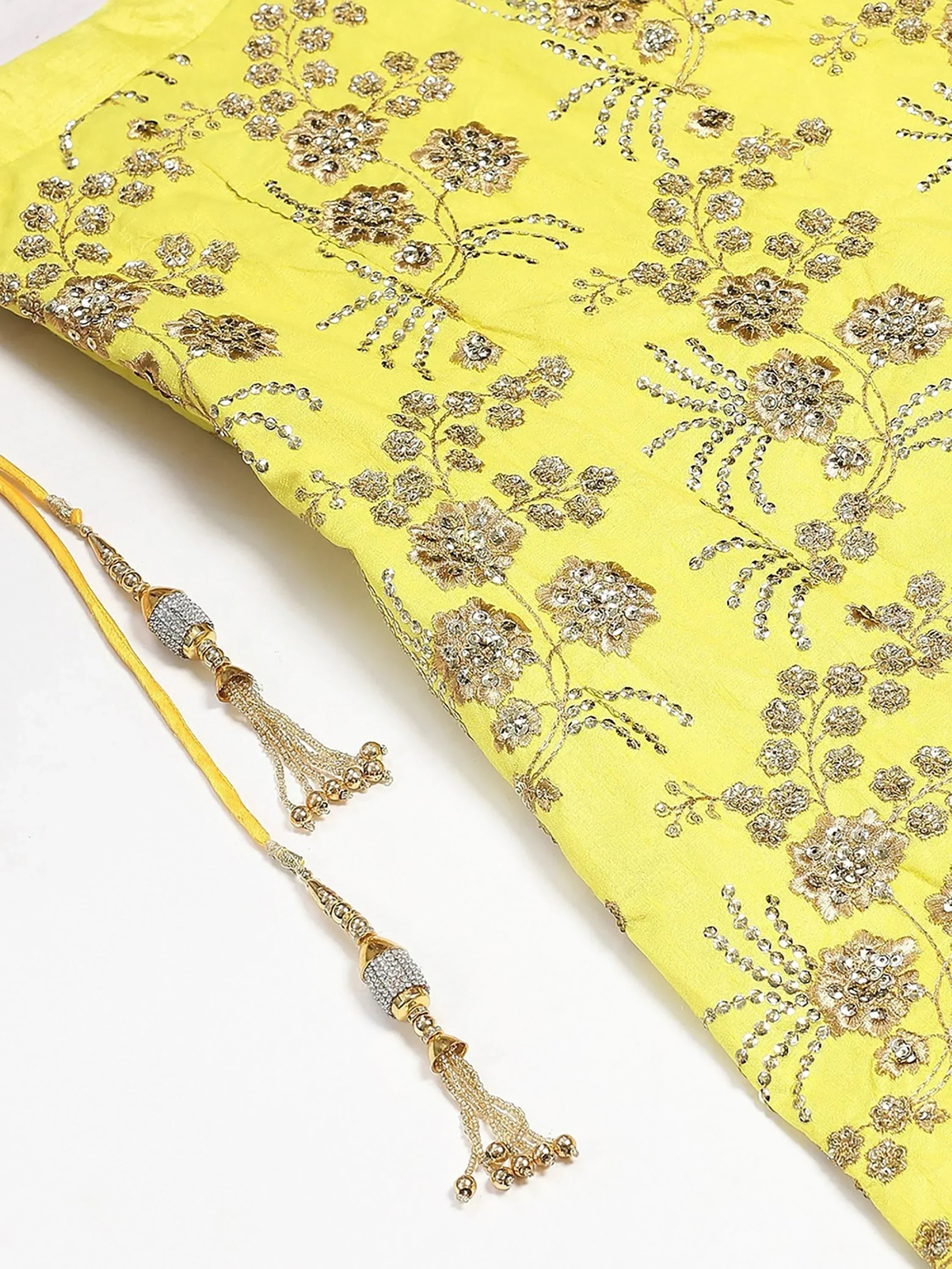 Yellow ethnic wear with gold floral embroidery and beaded tassels, perfect for Indian celebrations