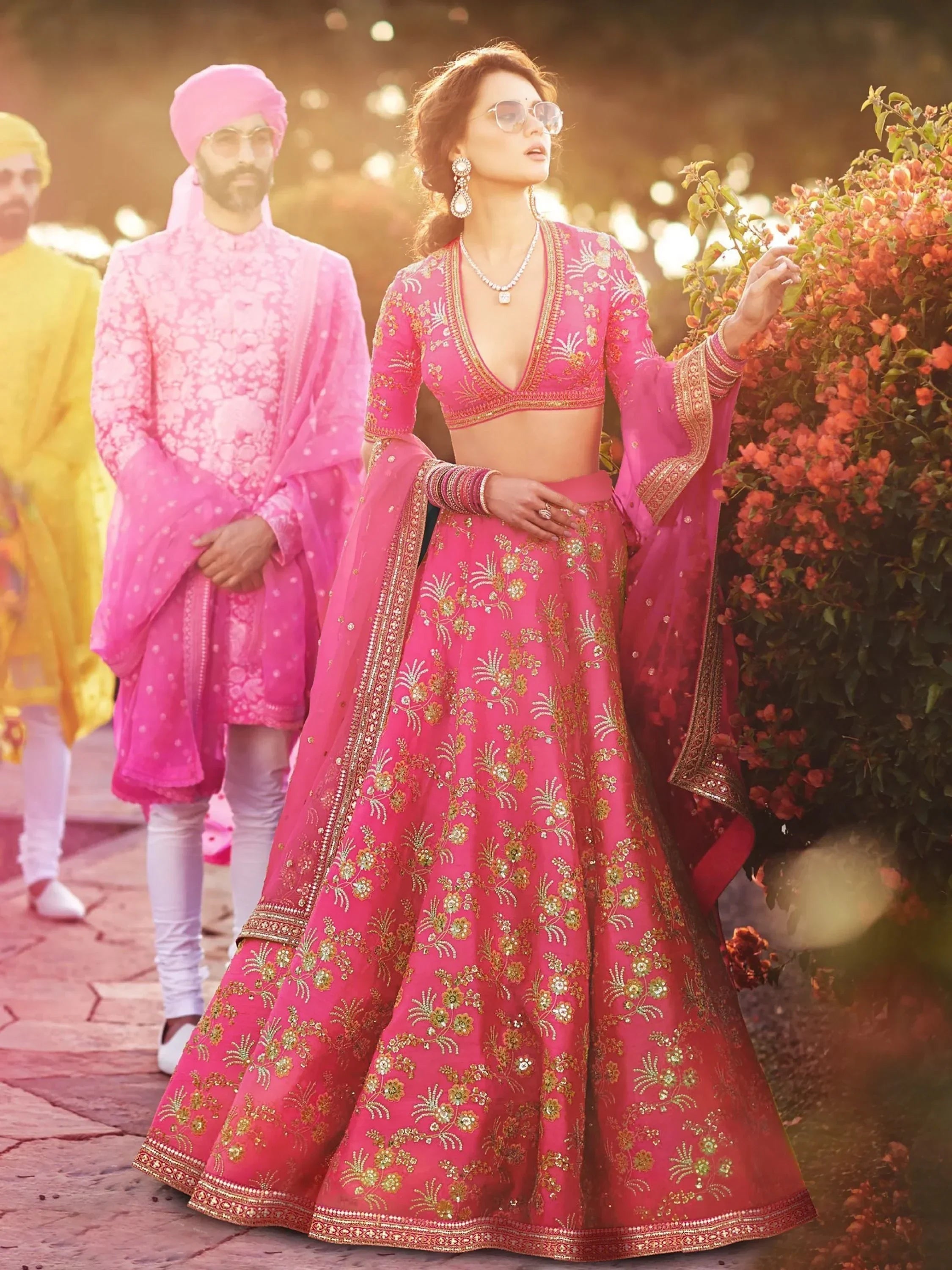 Pink embroidered lehenga choli with gold detailing, perfect for Indian weddings and festive occasions.