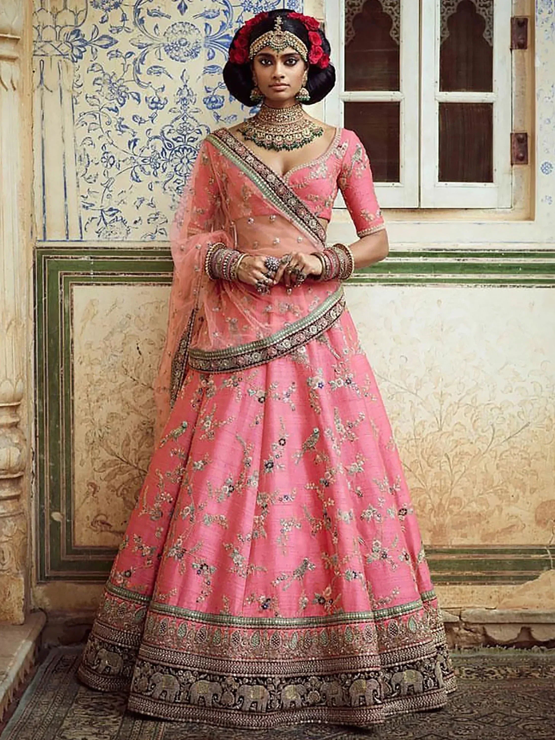 Pink embroidered lehenga choli with floral motifs and elephant border, traditional Indian bridal wear