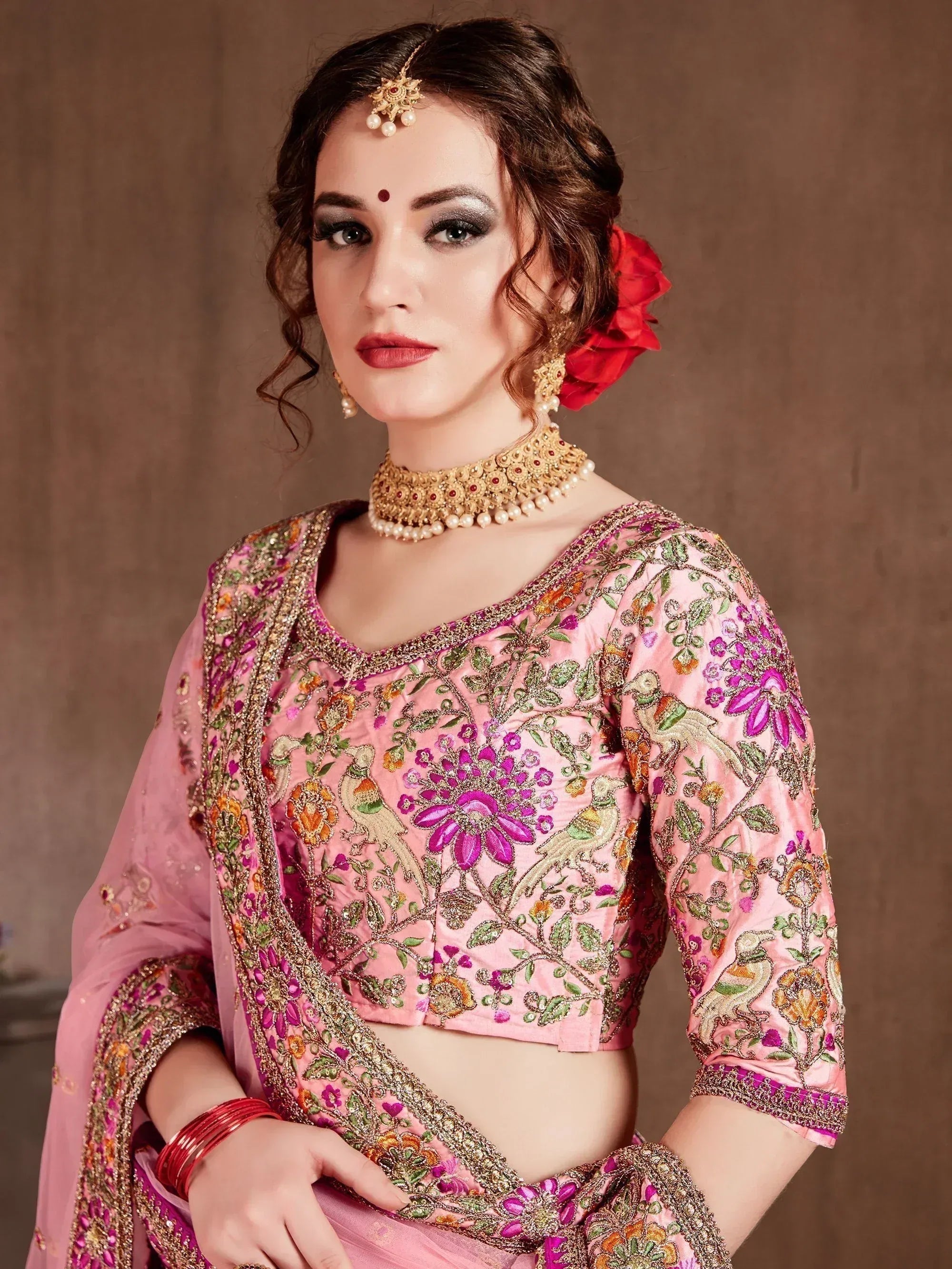 Pink embroidered lehenga choli with floral and bird motifs, traditional Indian ethnic wear