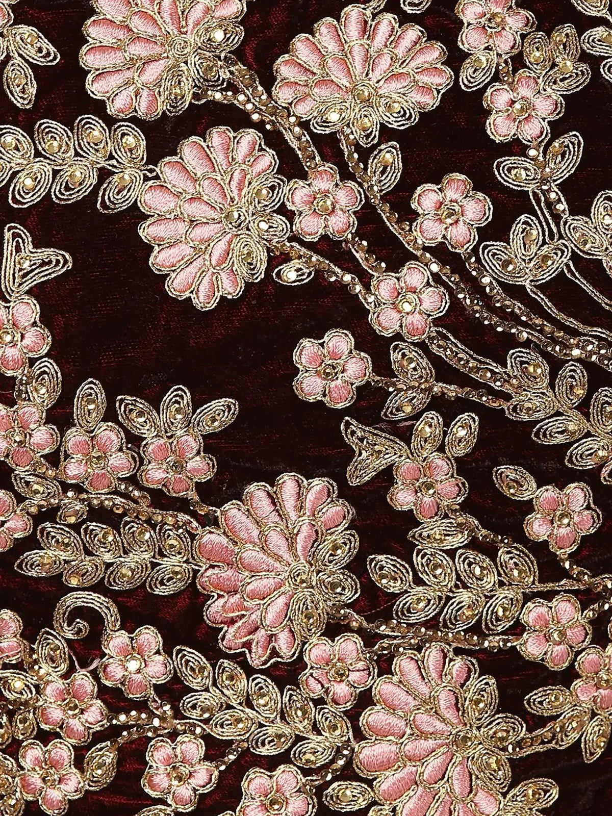 Intricate pink floral embroidery with gold thread and beads on maroon velvet fabric, ideal for ethnic wear.