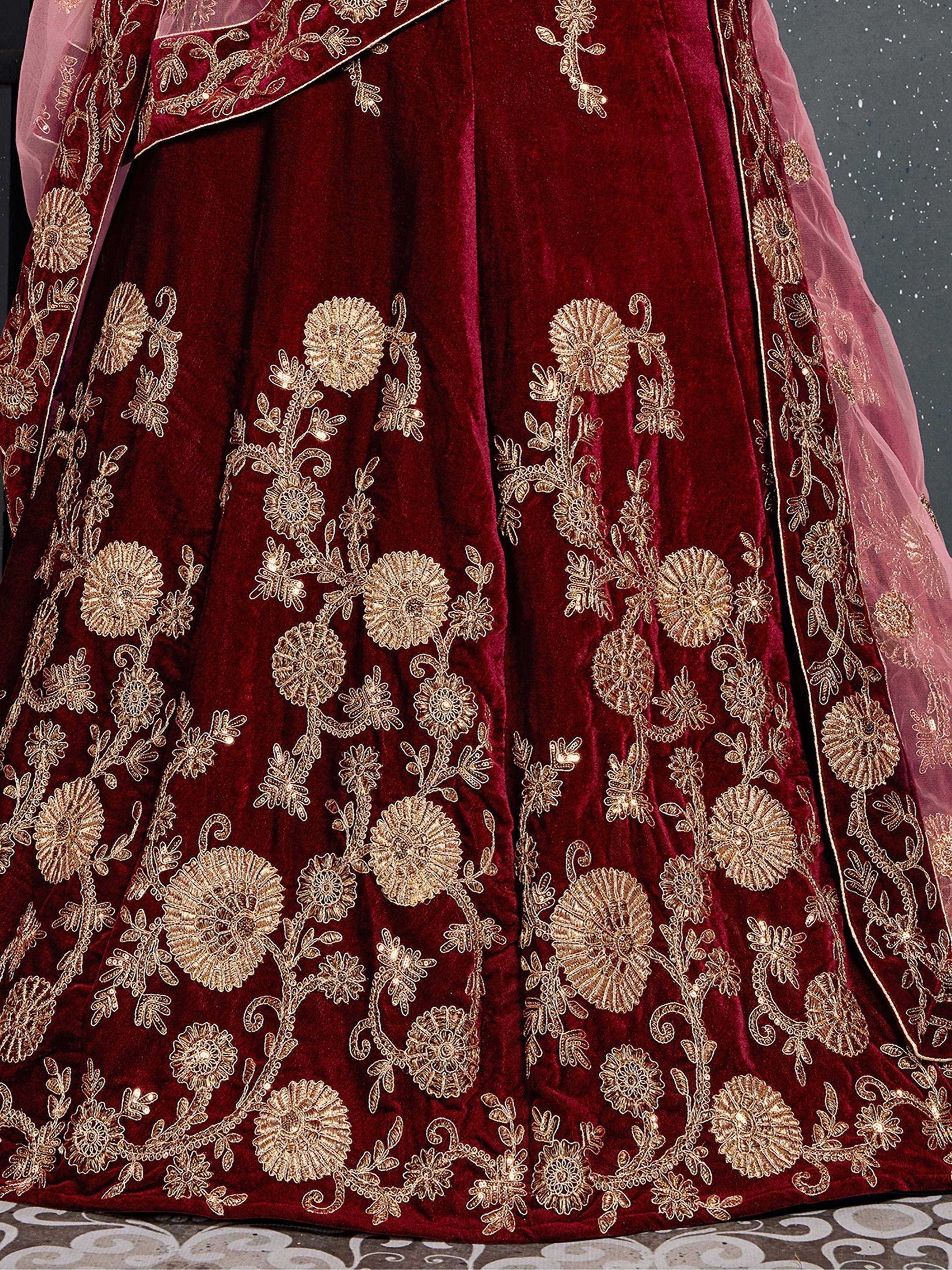 Rich maroon velvet lehenga with gold floral embroidery and sheer dupatta, perfect for Indian ethnic wear.