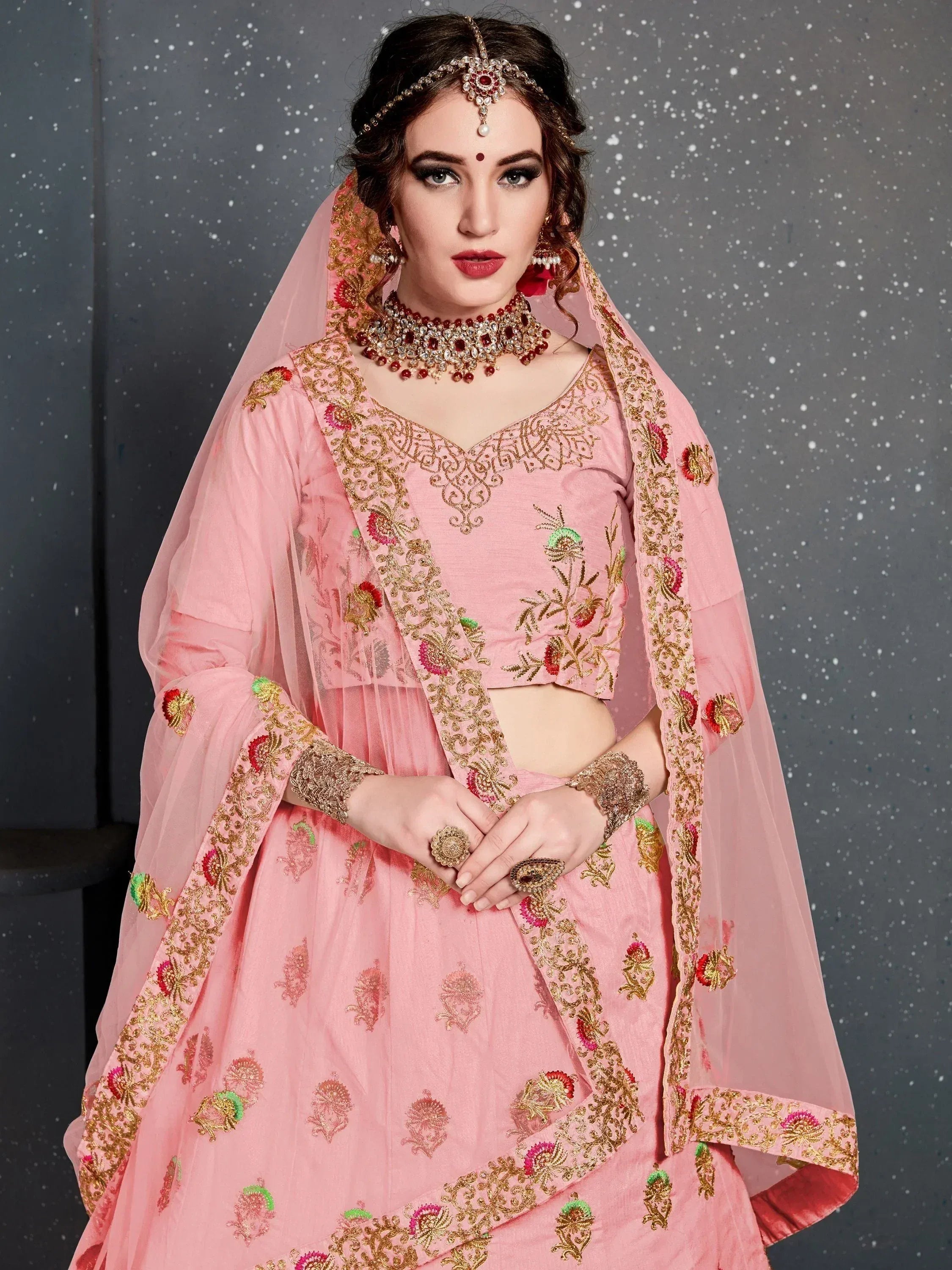Pink embroidered lehenga choli with gold floral work, perfect for Indian weddings and festive occasions.