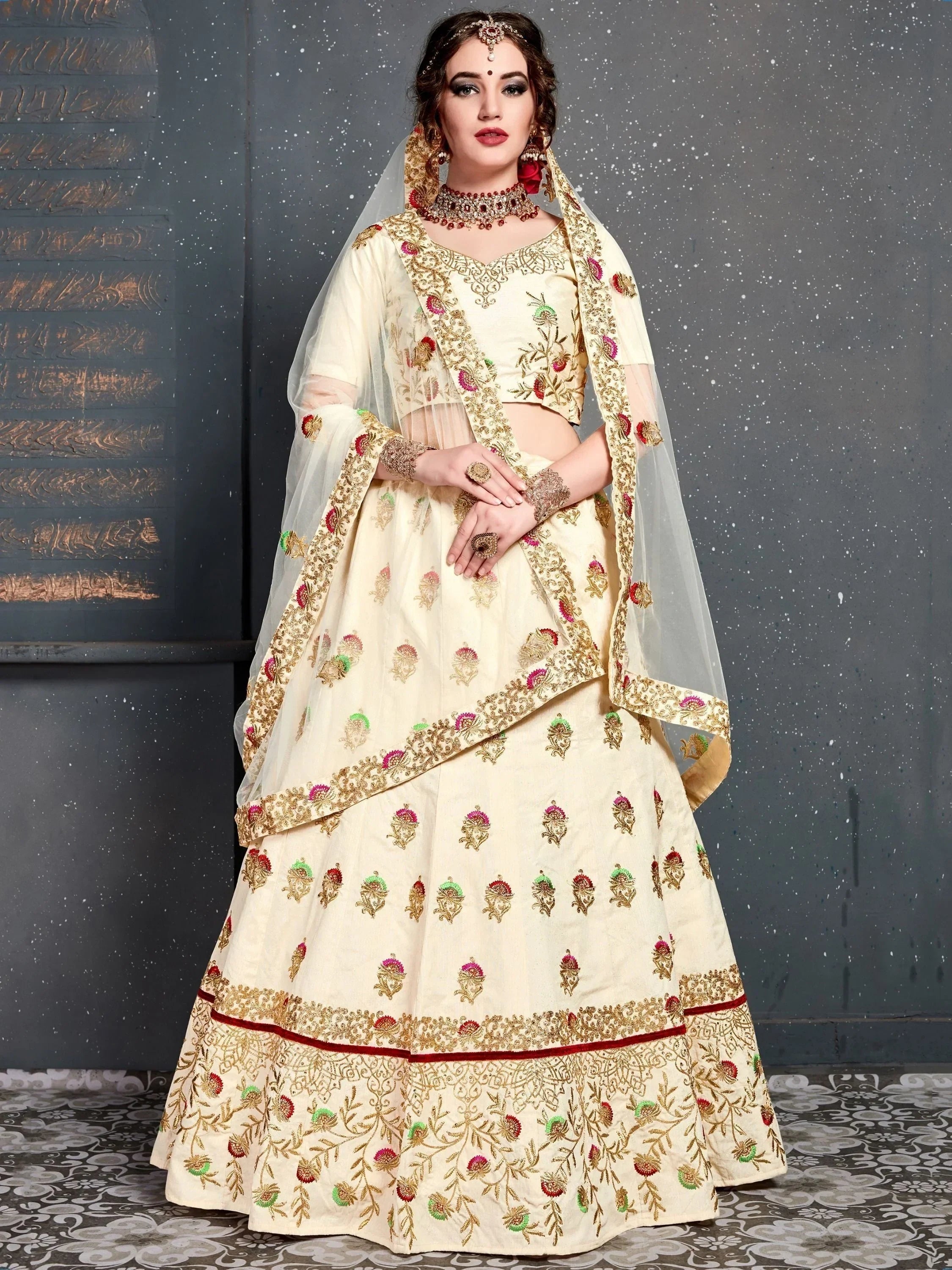 Cream embroidered lehenga choli with floral motifs, dupatta, and traditional jewelry for Indian weddings.