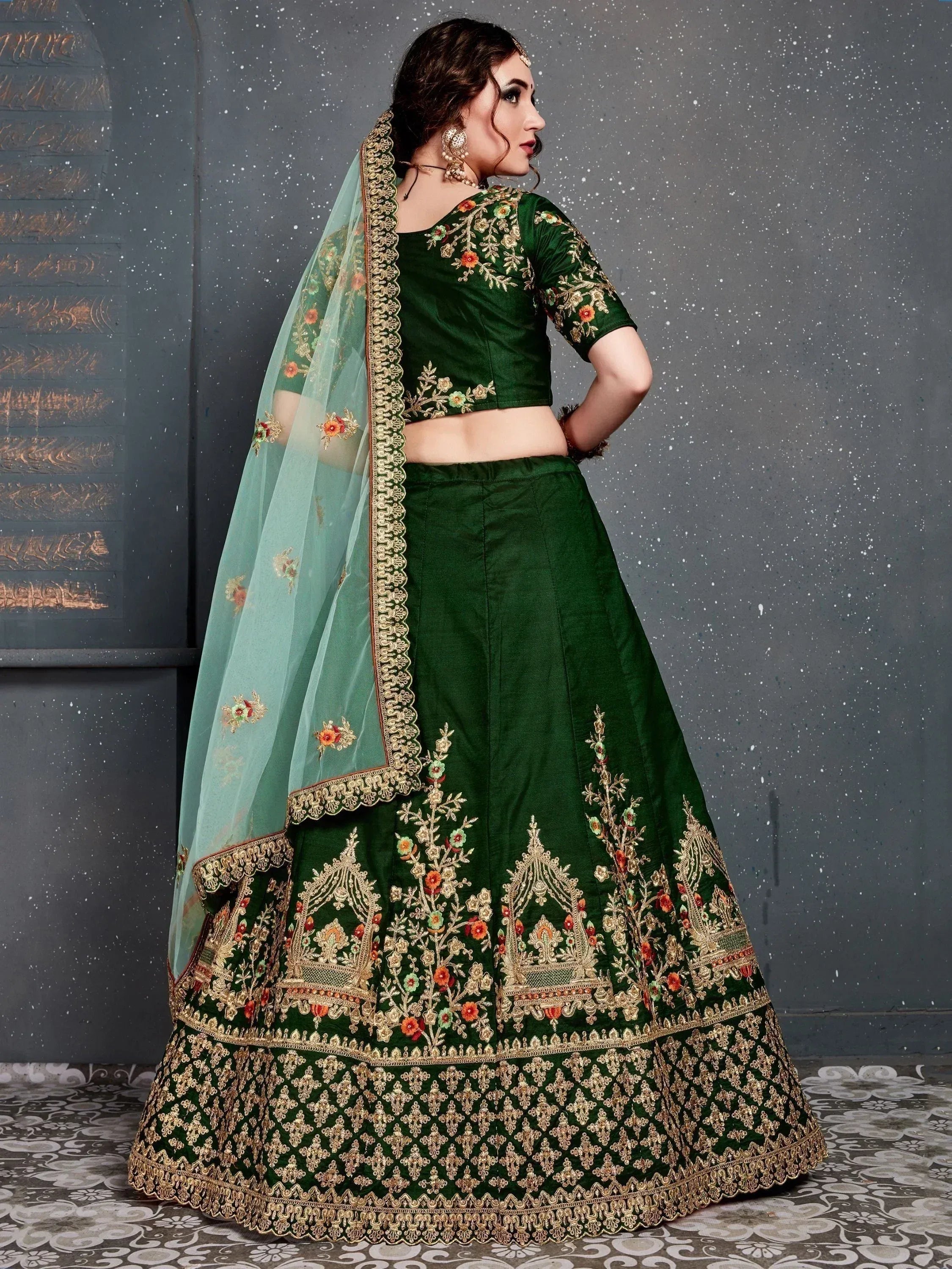 Emerald green embroidered lehenga choli with floral motifs and sheer dupatta, ideal for Indian weddings and festive occasions.