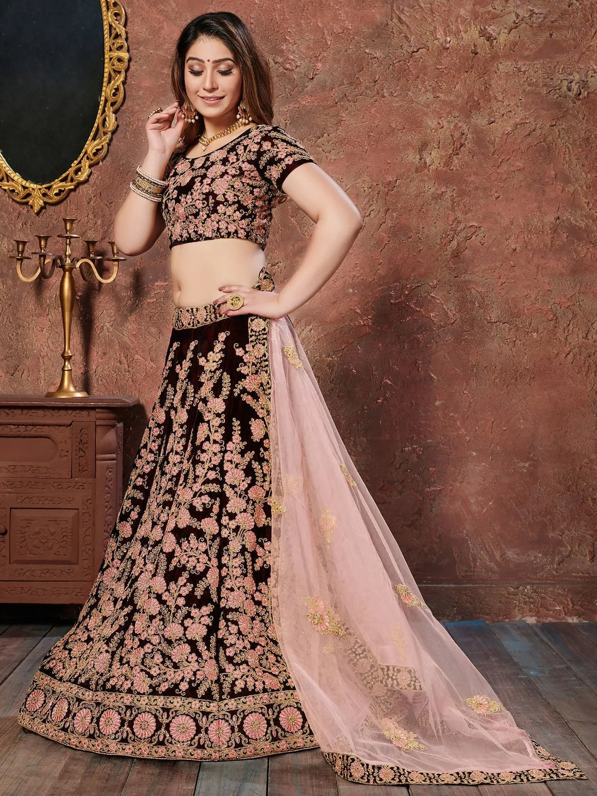Elegant maroon lehenga choli with pink floral embroidery and sheer dupatta, perfect for Indian weddings and festive occasions.