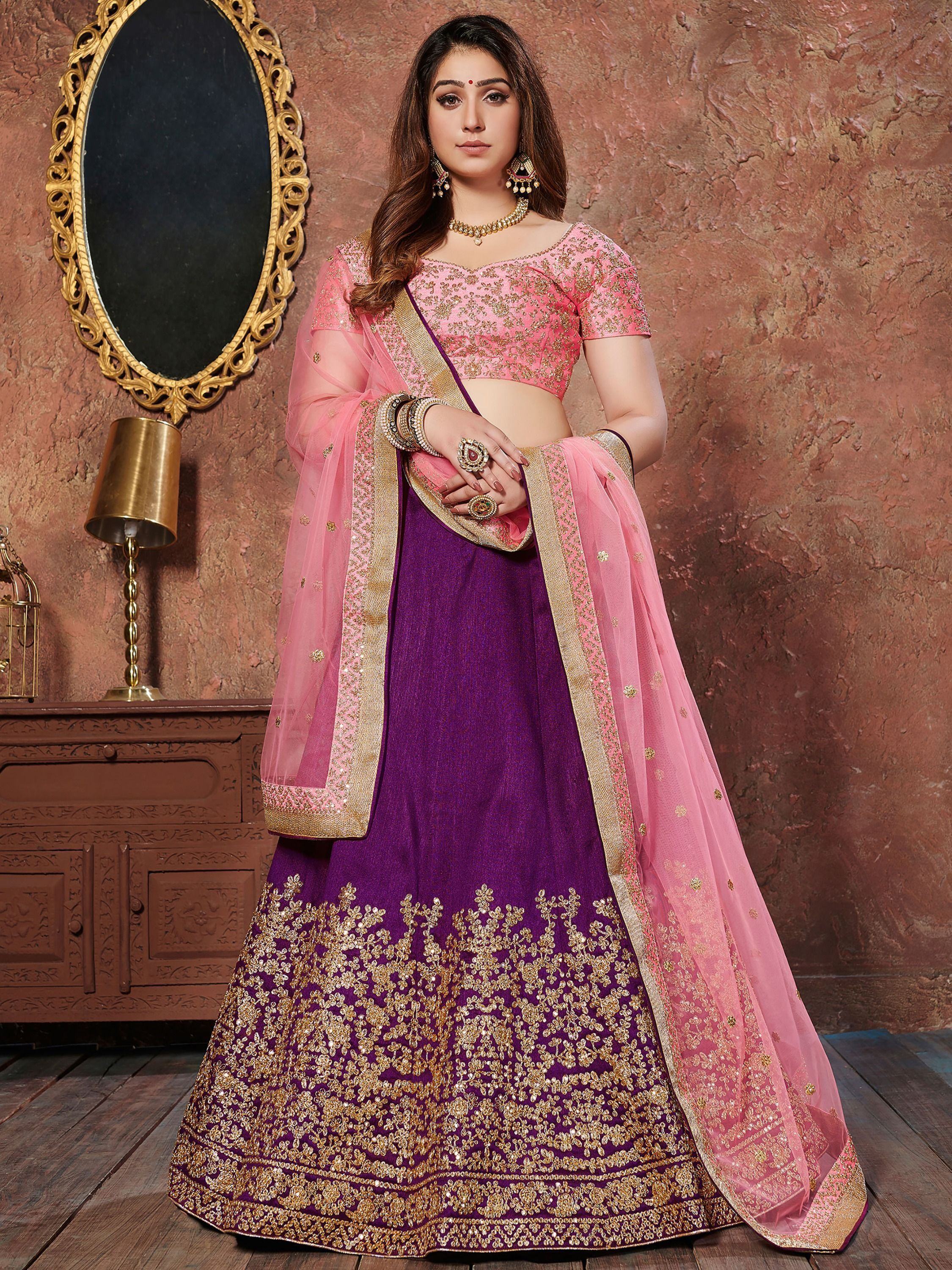 Purple and pink embroidered lehenga choli with gold detailing, perfect for Indian weddings and festive occasions.