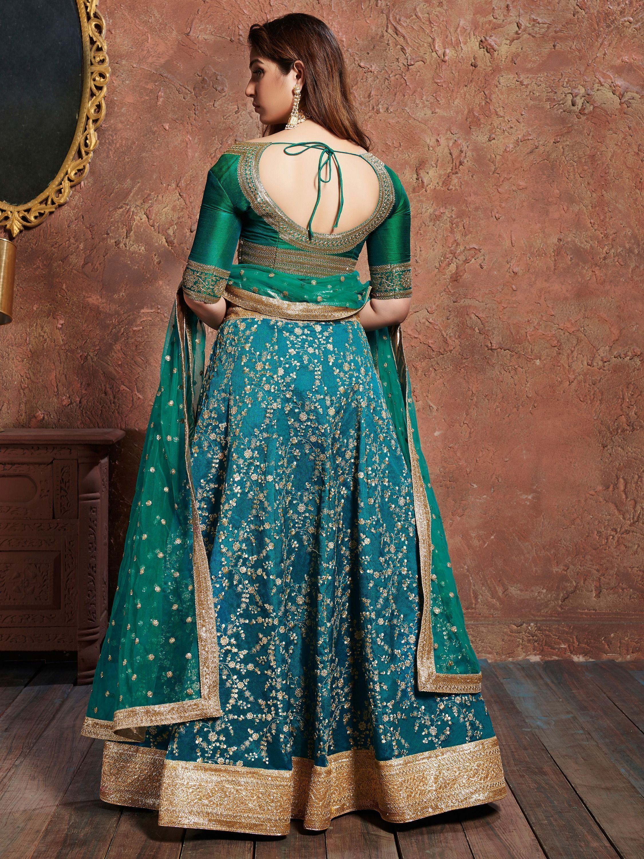 Emerald green lehenga choli with gold floral embroidery and open back design, ideal for Indian ethnic wear.