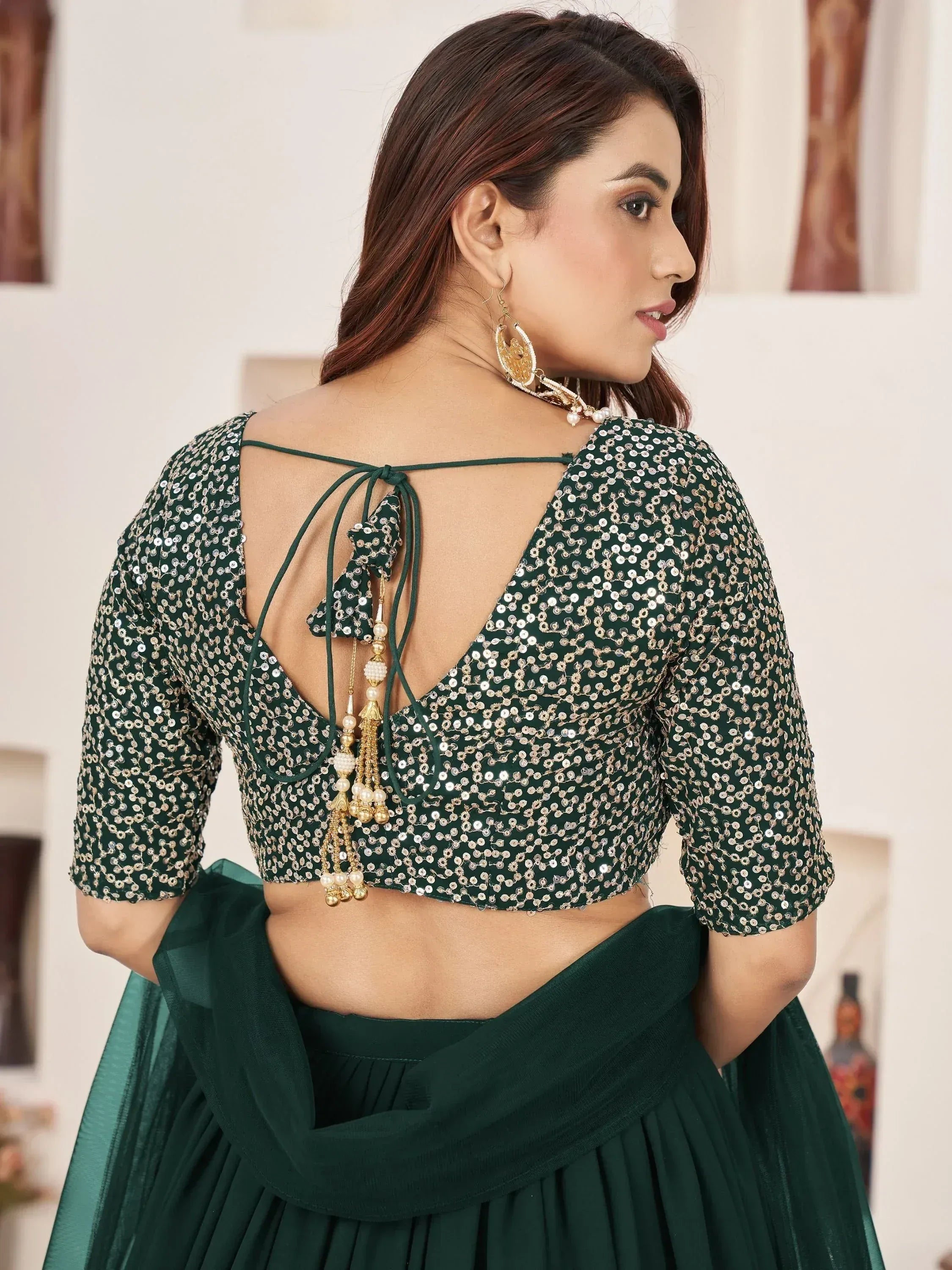 Emerald green sequin lehenga choli with back tie-up and tassels, Indian ethnic wear