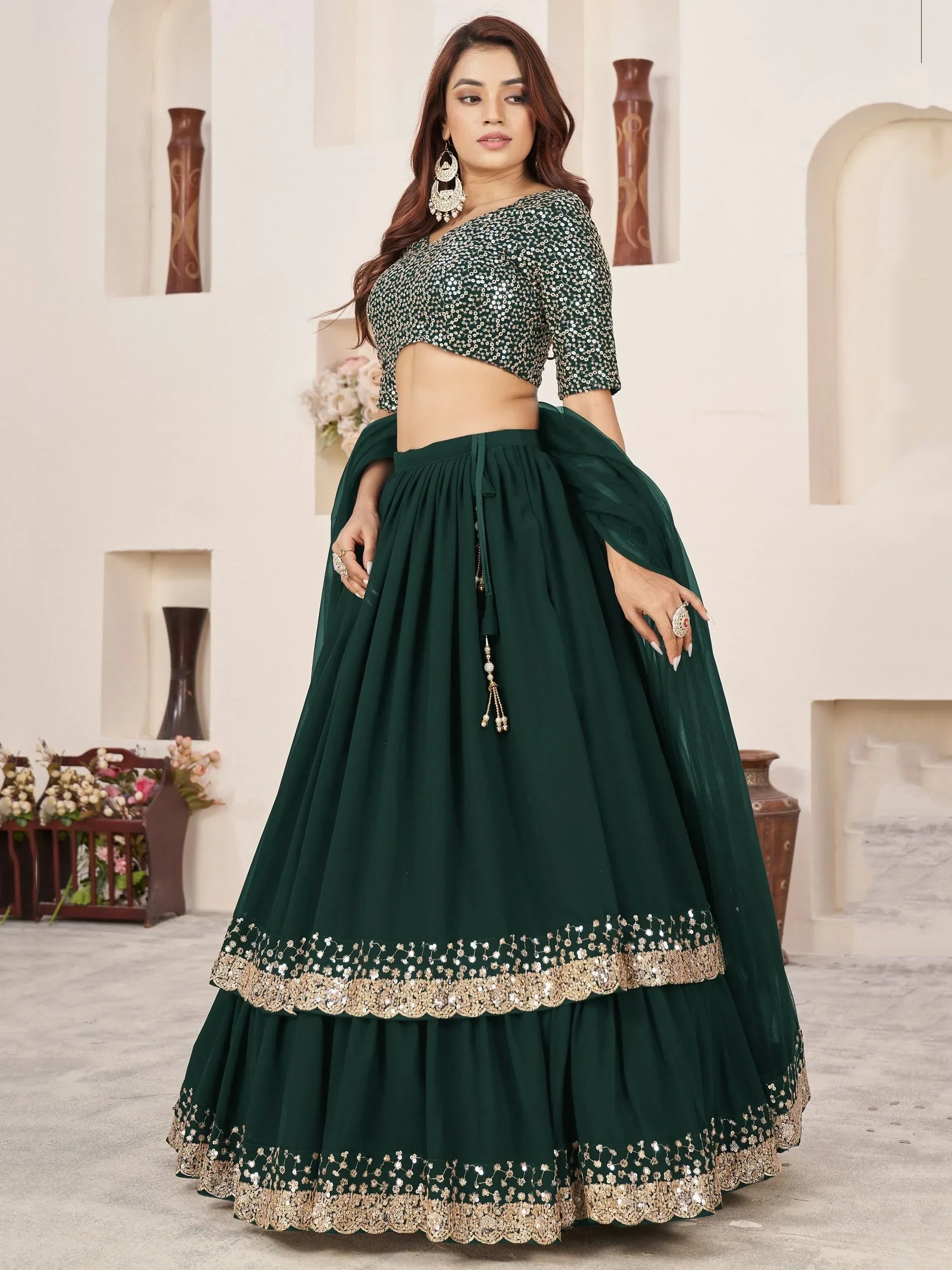Emerald green designer lehenga choli with sequin work and gold embroidery, perfect for Indian ethnic occasions.