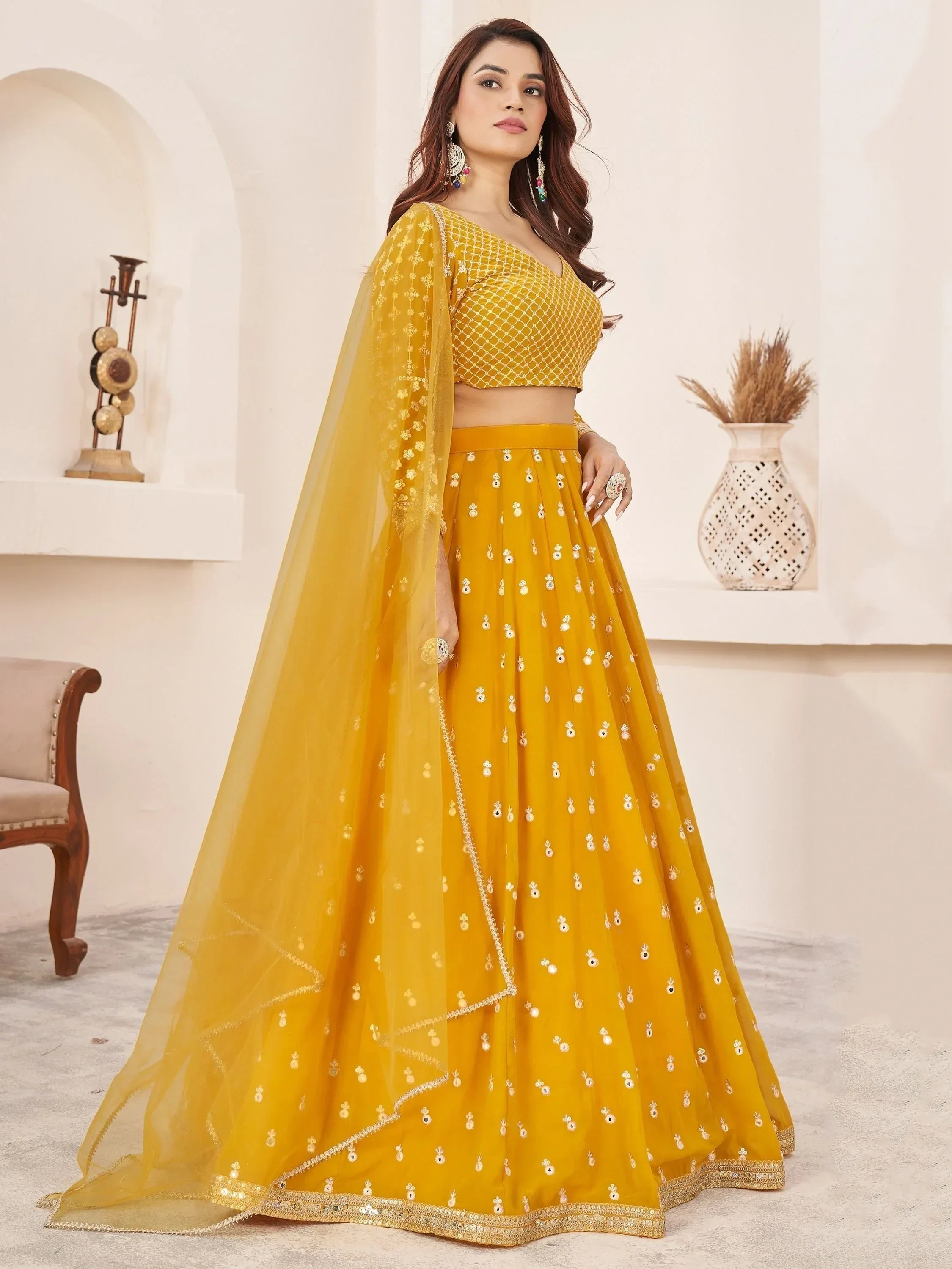Yellow designer lehenga choli with mirror work and net dupatta for Indian ethnic wear