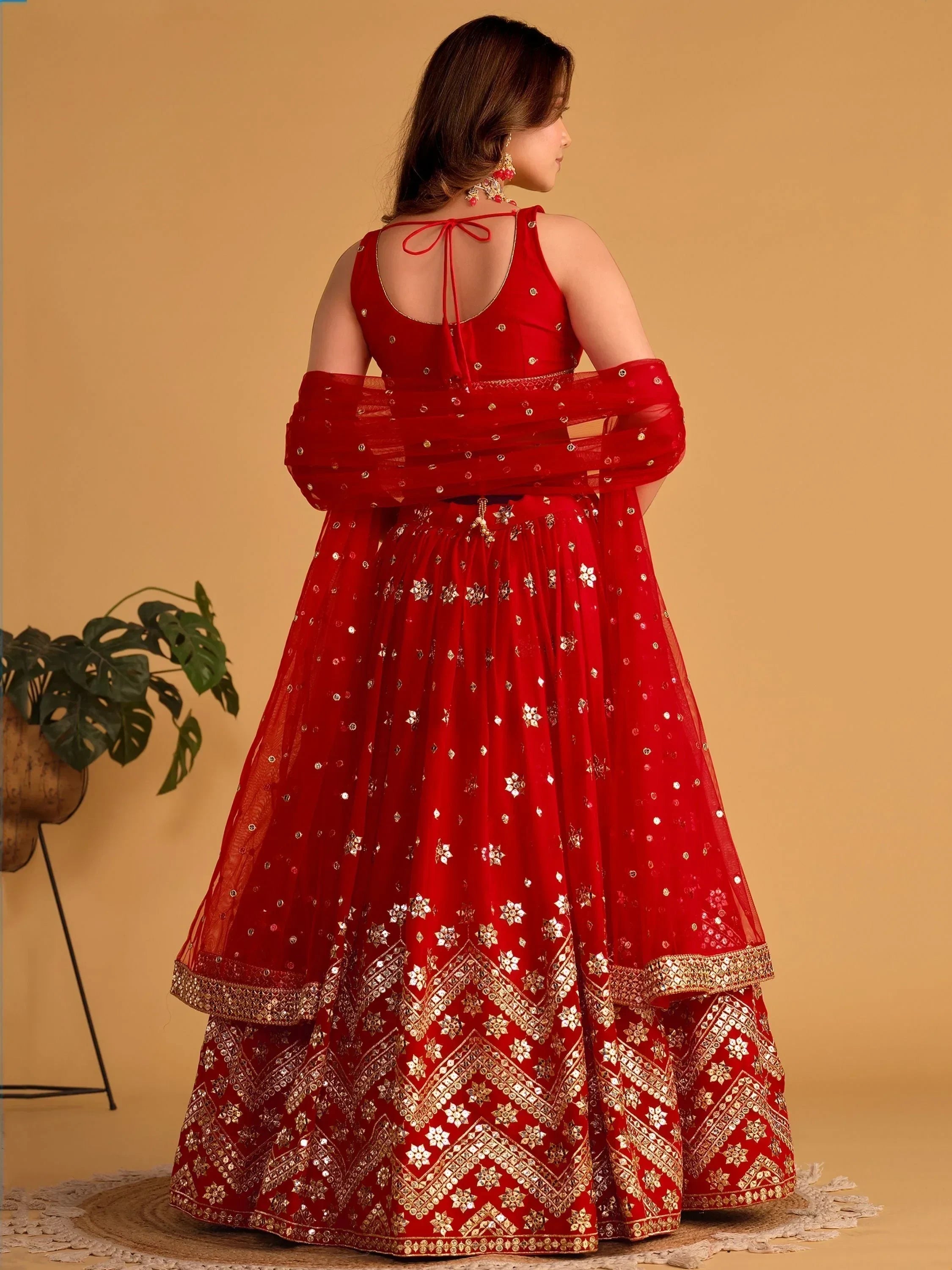 Red designer lehenga choli with gold mirror work, back view, ethnic wear for women