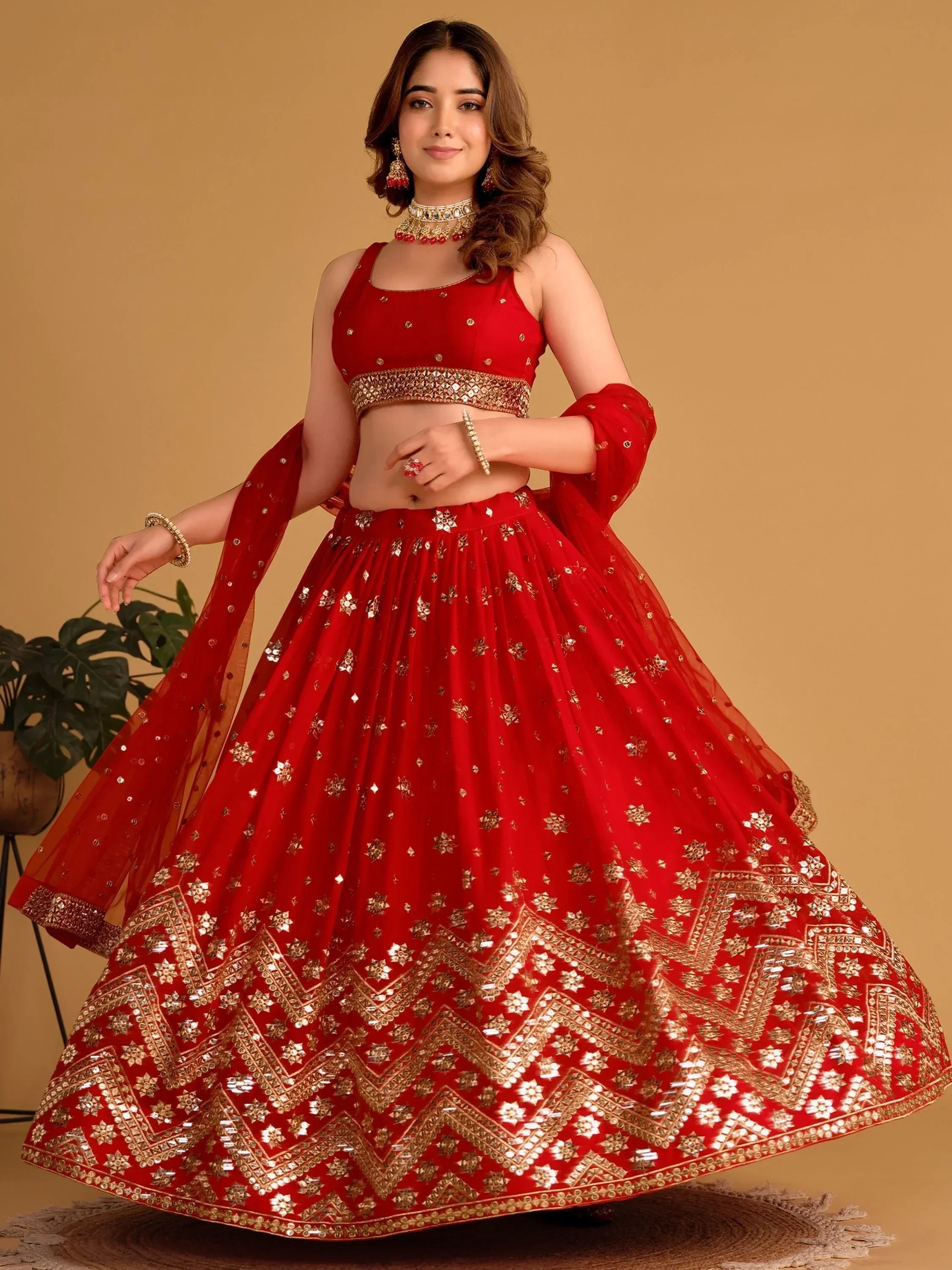 Red designer lehenga choli with gold mirror work, perfect for Indian ethnic wear and festive occasions.