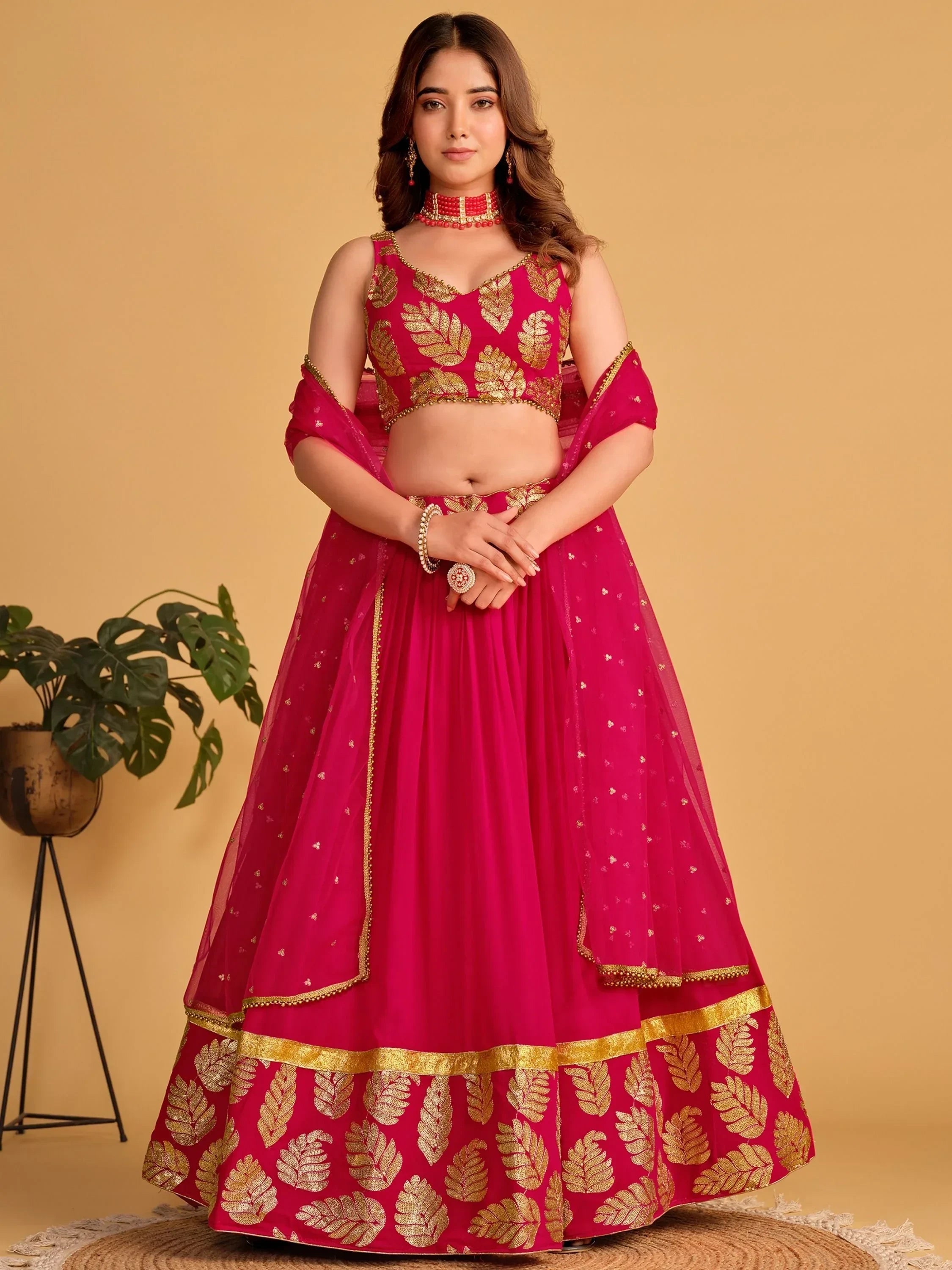Pink lehenga choli with gold leaf embroidery, perfect for Indian weddings and festive occasions