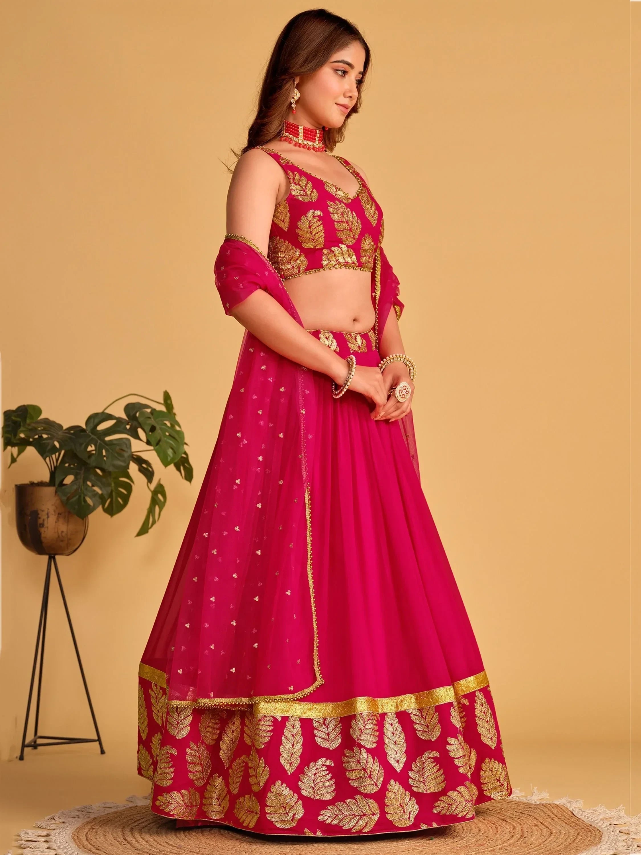 Pink lehenga choli with gold leaf embroidery, perfect for Indian weddings and festive occasions