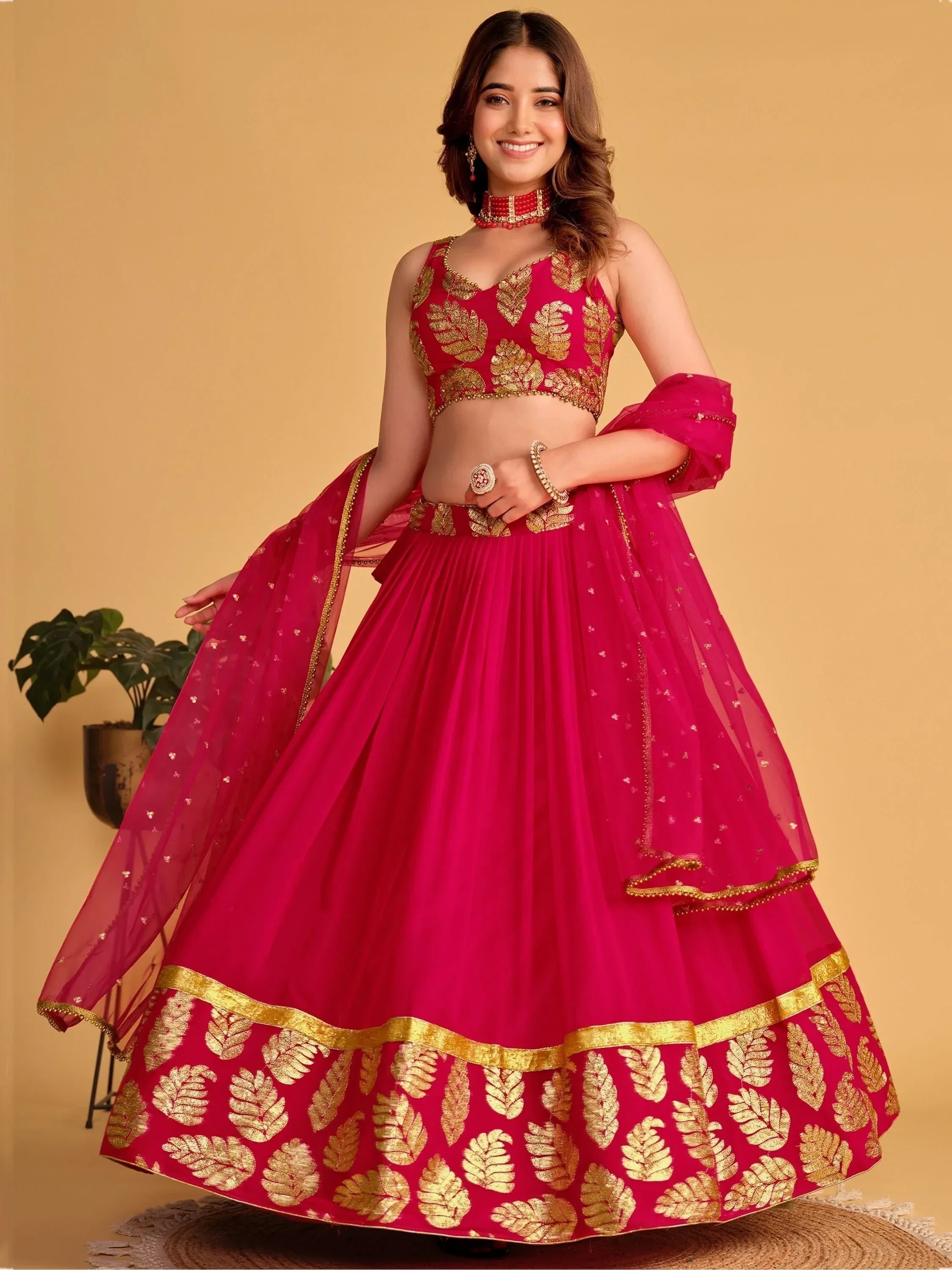 Fuchsia lehenga choli with gold leaf embroidery, perfect for Indian weddings and festive occasions