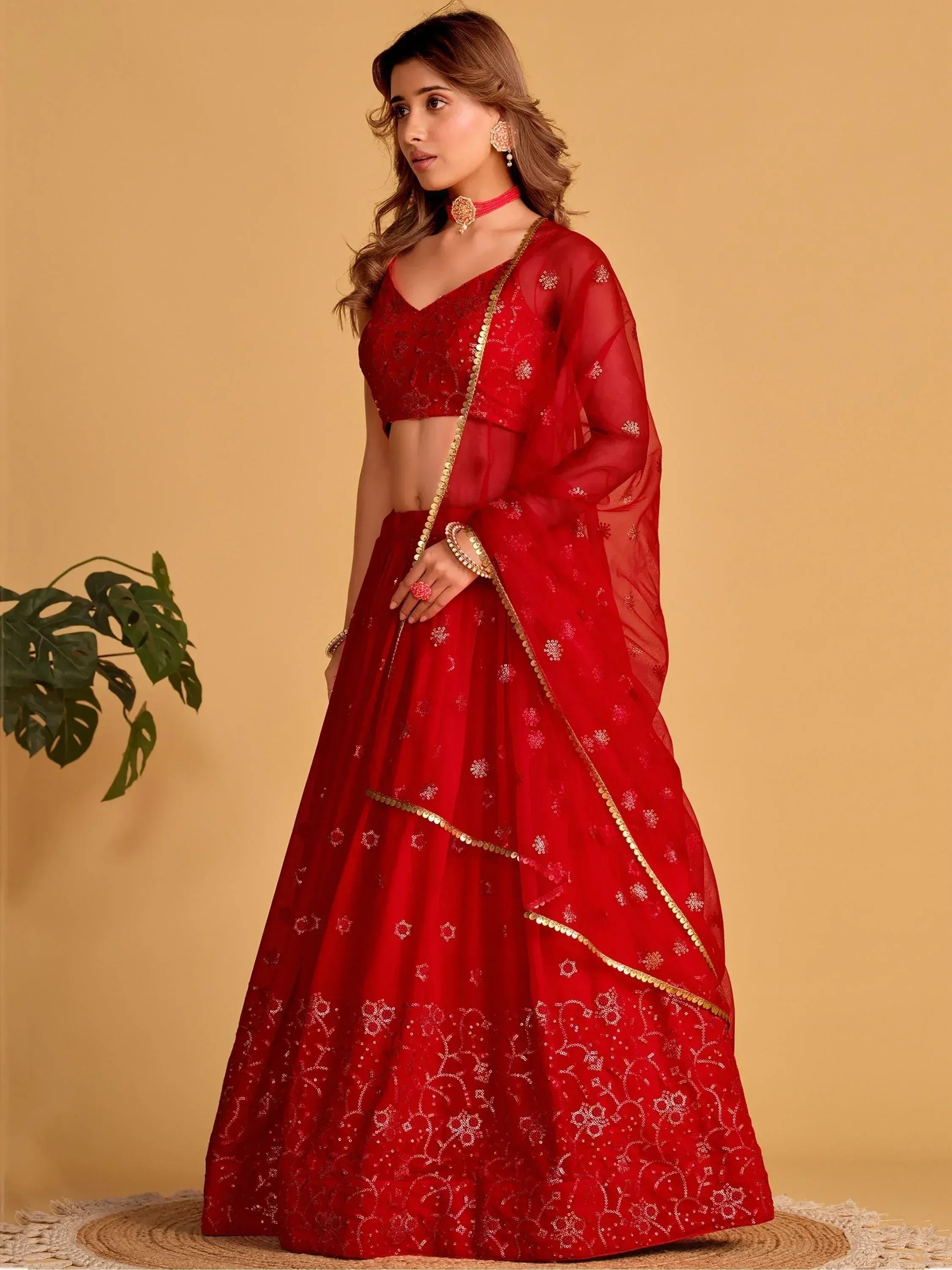 Red embroidered lehenga choli with gold detailing, perfect for Indian weddings and festive occasions