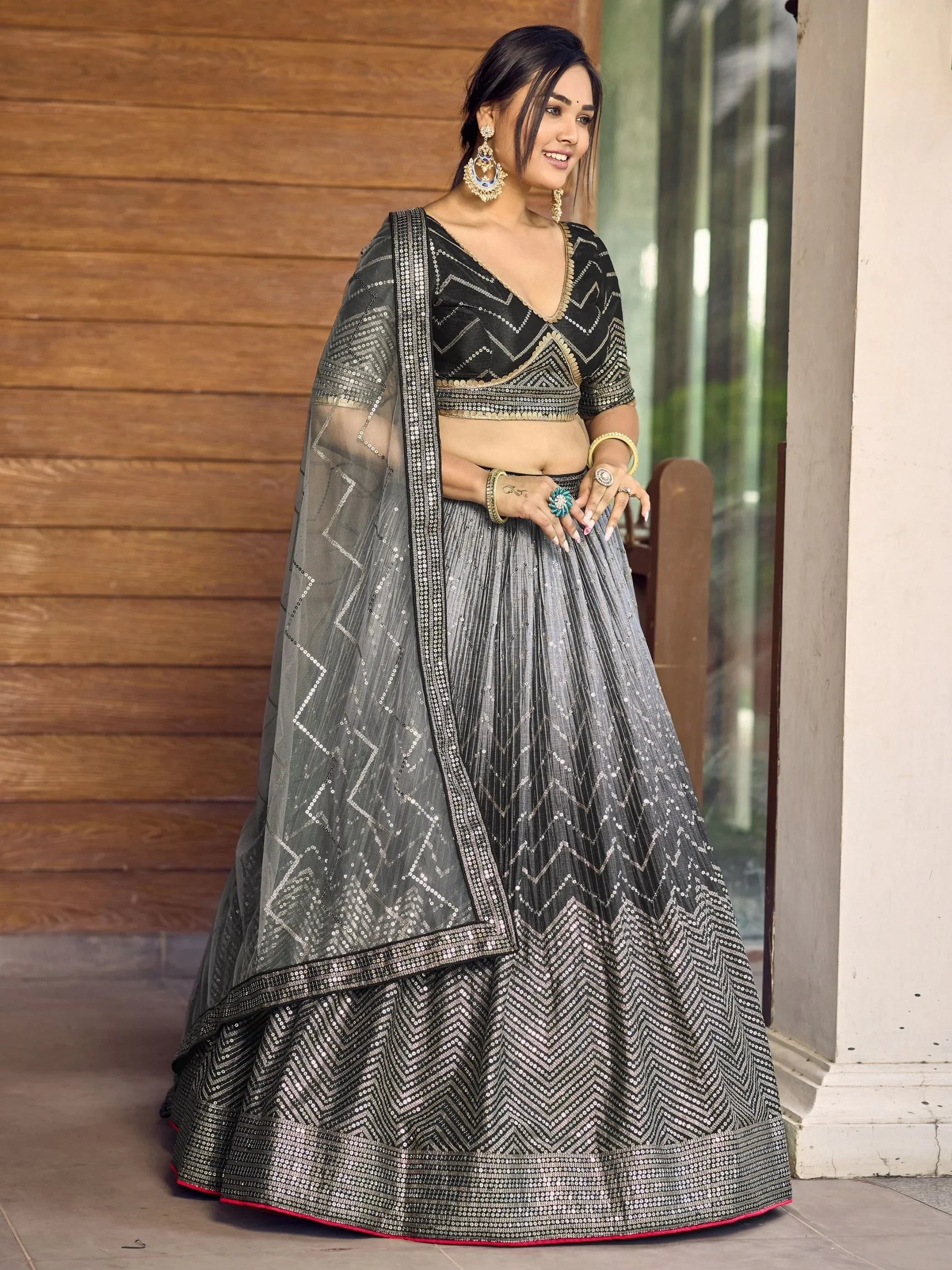 Black and silver sequin lehenga choli with geometric patterns, perfect for Indian ethnic wear occasions.