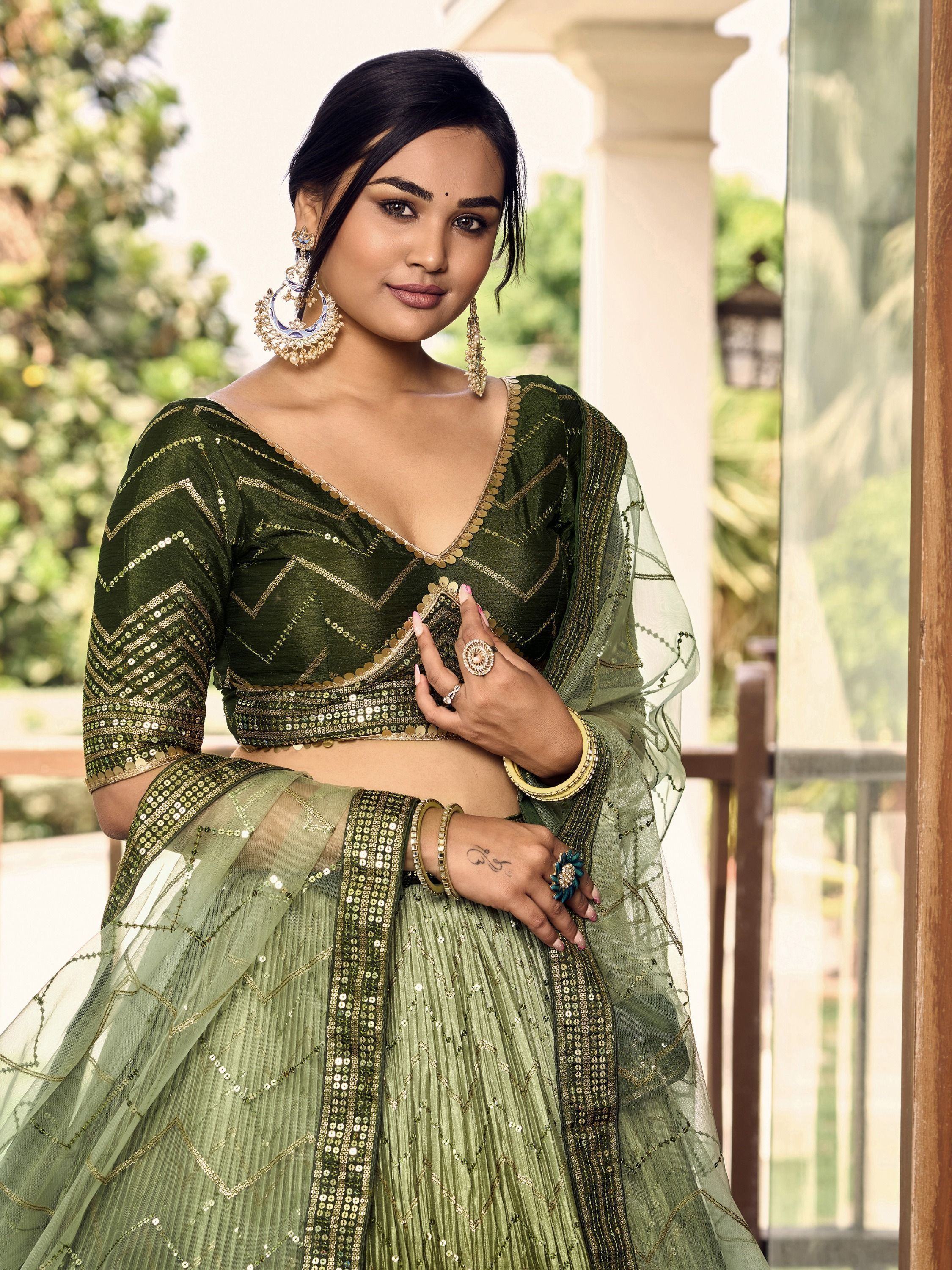 Green sequin lehenga choli with gold embroidery, perfect for Indian ethnic wear and festive occasions.