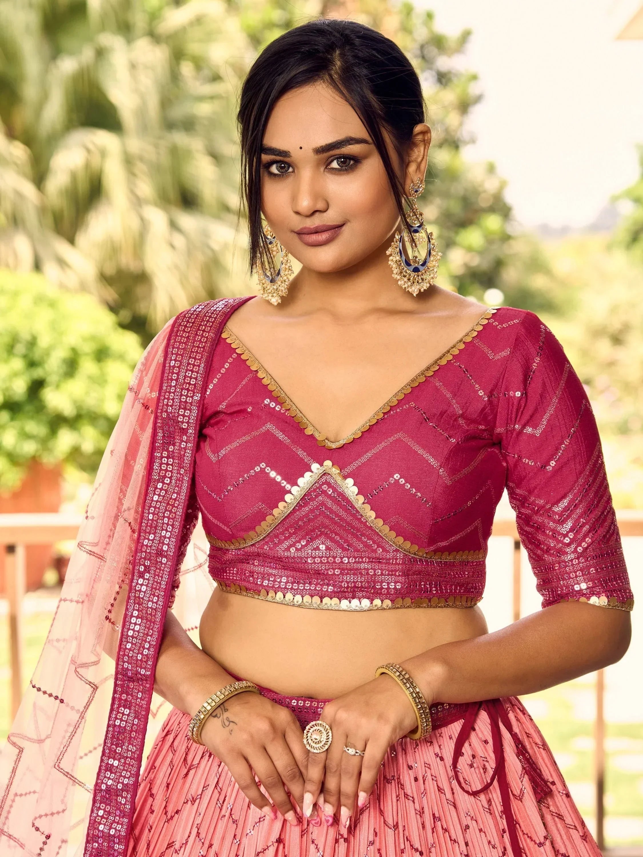 Pink sequined lehenga choli with gold trim, perfect for Indian ethnic wear and festive occasions.