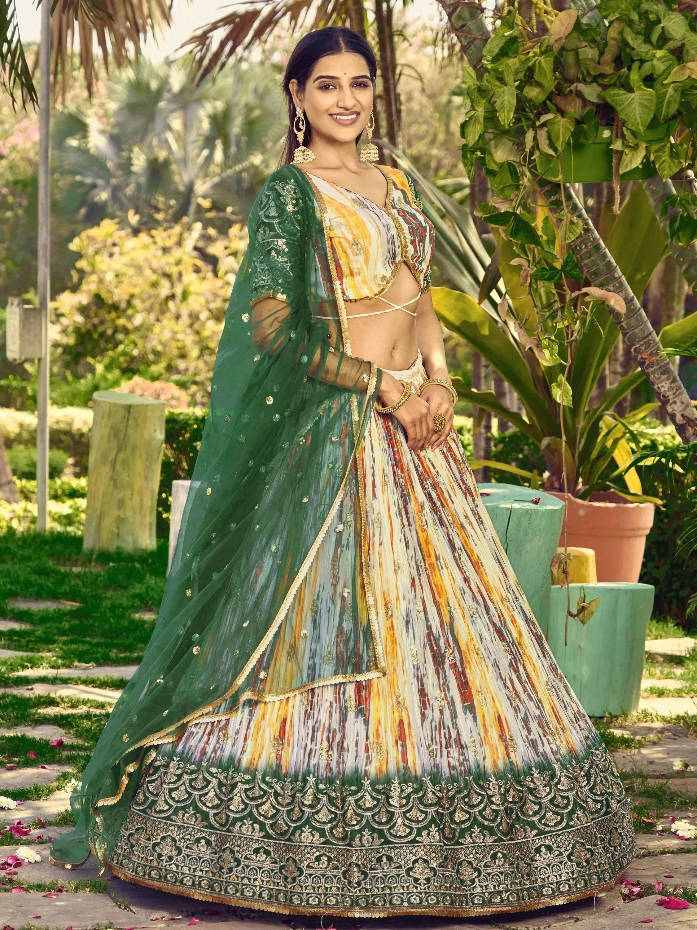 Woman in colorful printed lehenga choli with green dupatta, perfect for Indian ethnic occasions