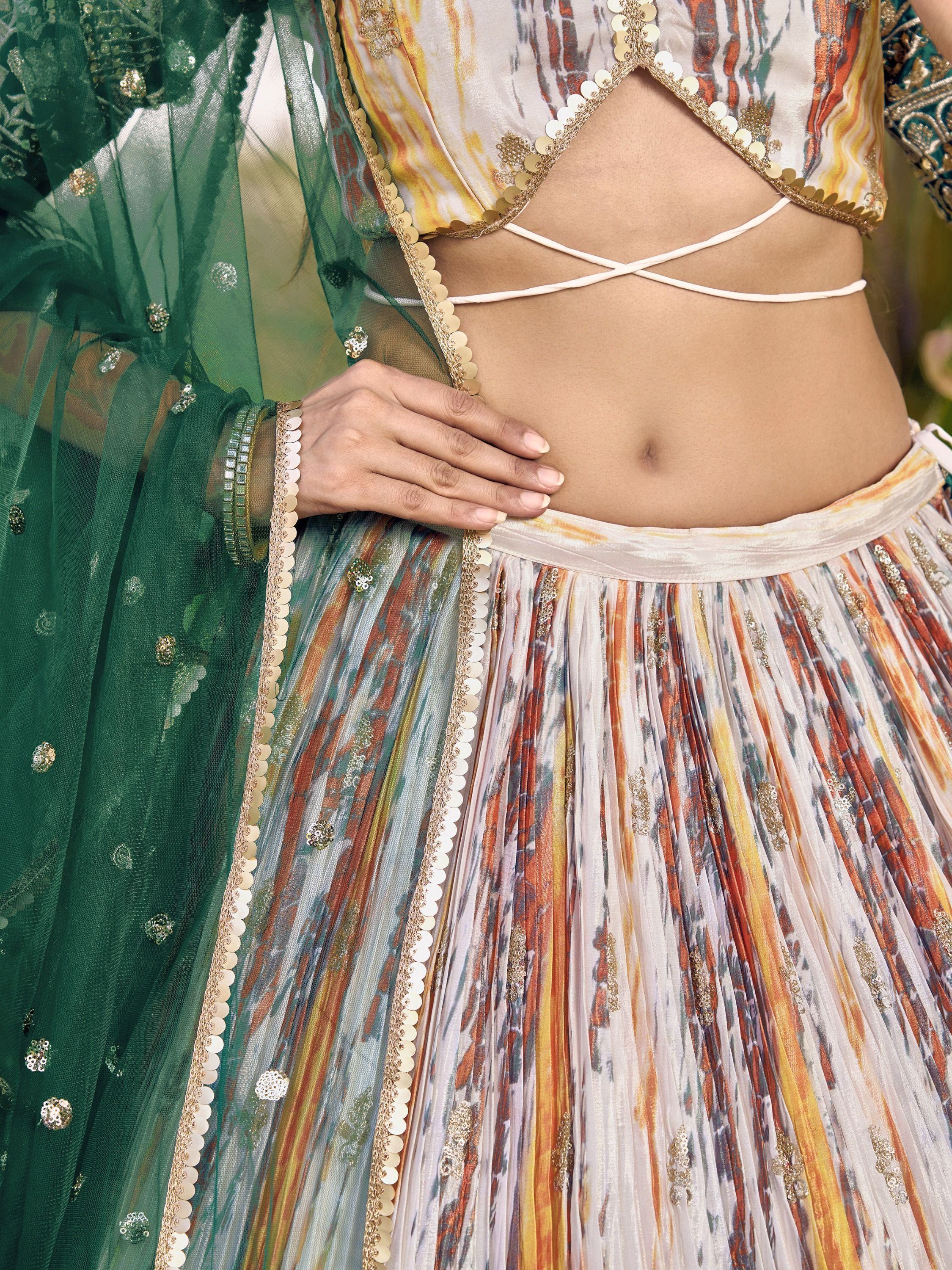 Designer lehenga choli with printed pleated skirt, gold embellishments, and green dupatta for ethnic wear