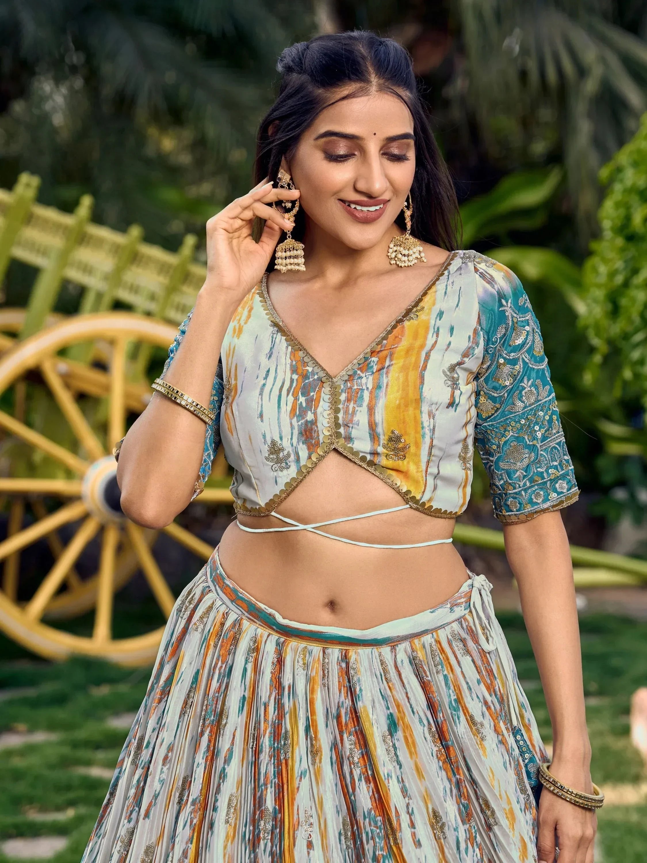 Woman in colorful printed lehenga choli with gold embroidery, traditional Indian ethnic wear for festive occasions