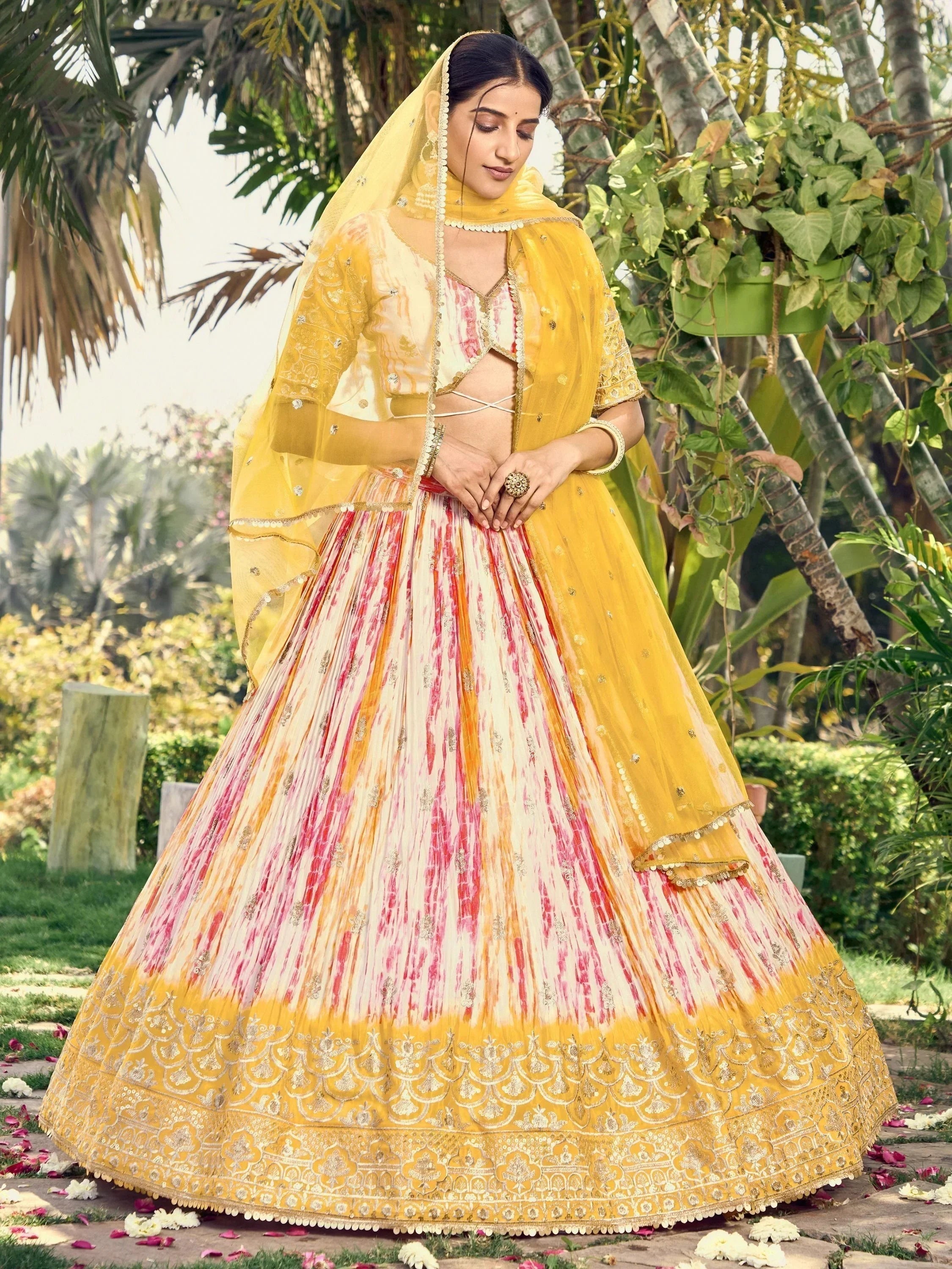 Yellow and pink tie-dye lehenga choli with gold embroidery, perfect for Indian ethnic wear occasions
