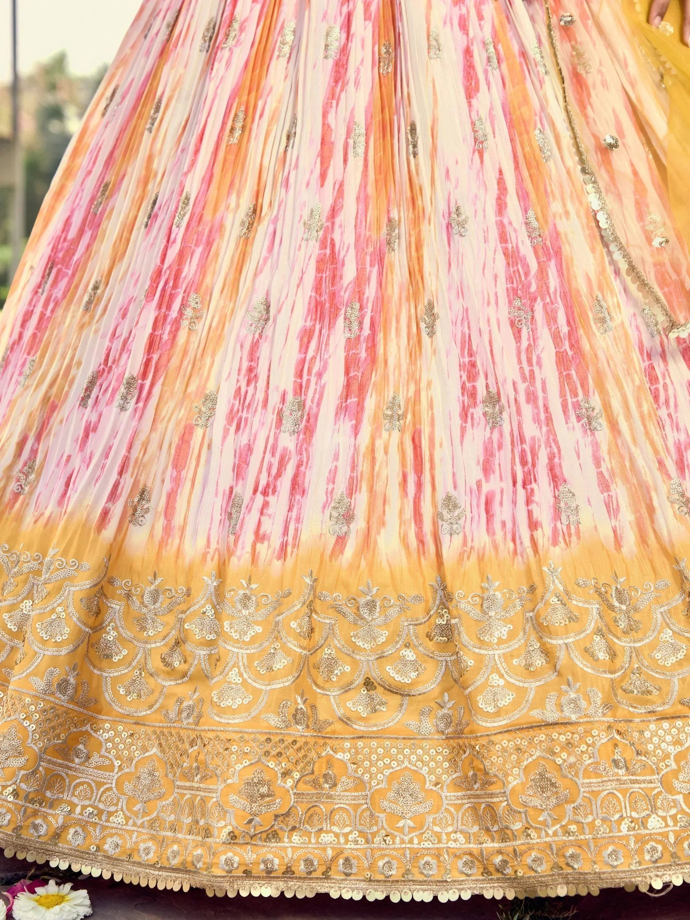 Pink and gold embroidered lehenga skirt with tie-dye pattern and intricate border detailing