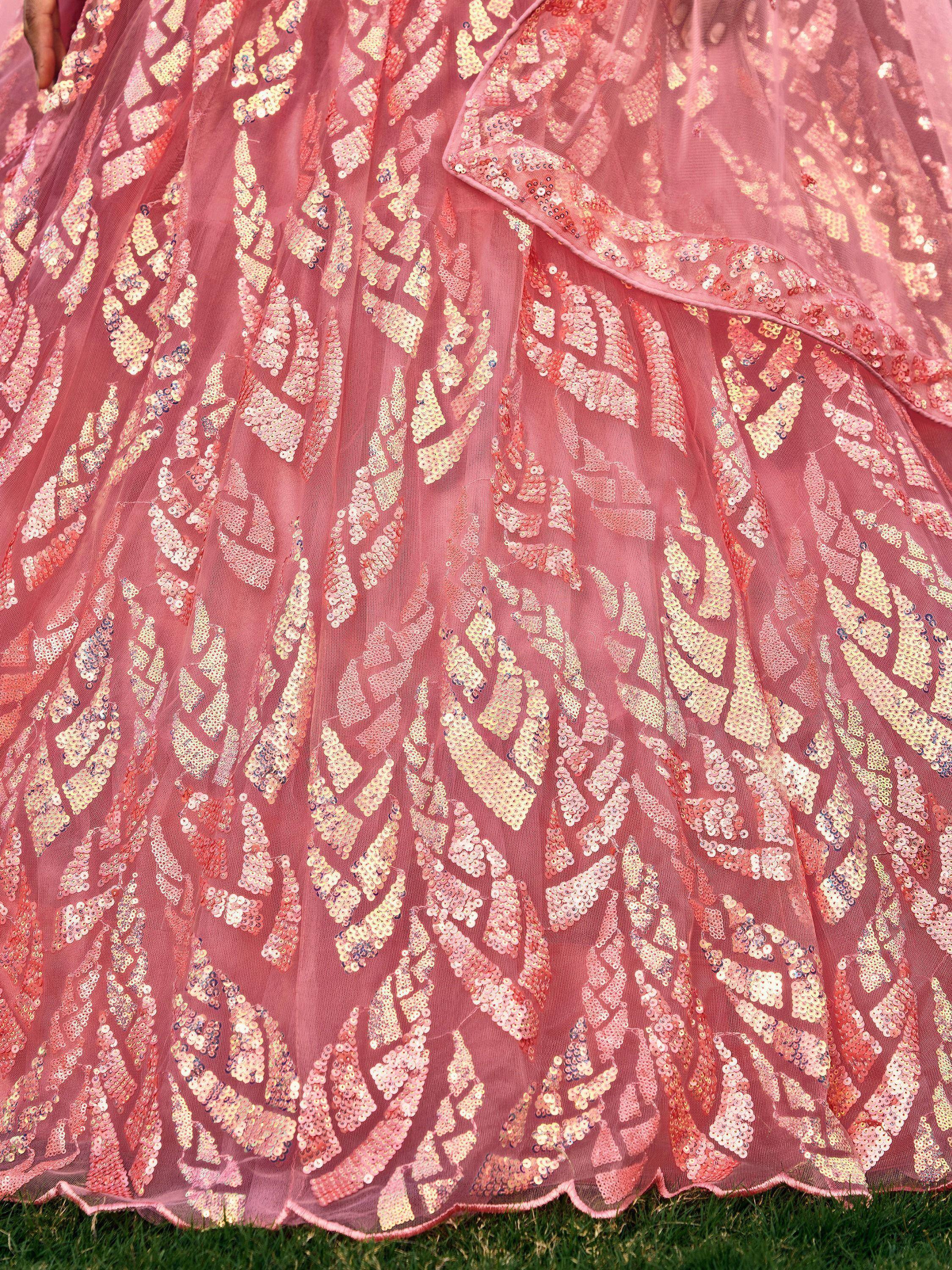 Pink sequin-embellished ethnic lehenga skirt with gold floral patterns, perfect for Indian weddings and festive occasions.