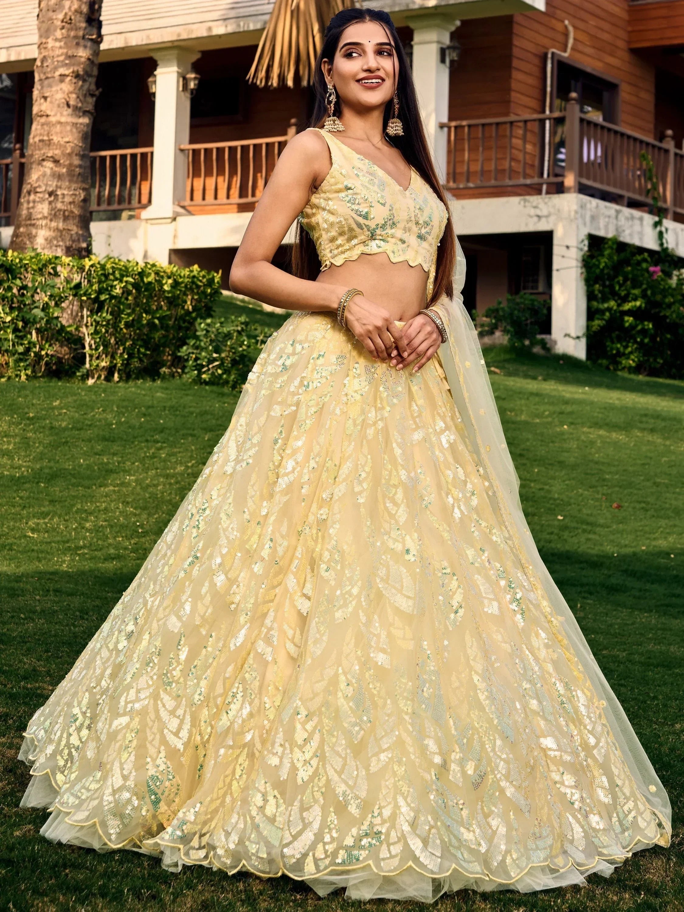 Yellow sequin lehenga choli with floral embroidery, perfect for Indian weddings and festive occasions.