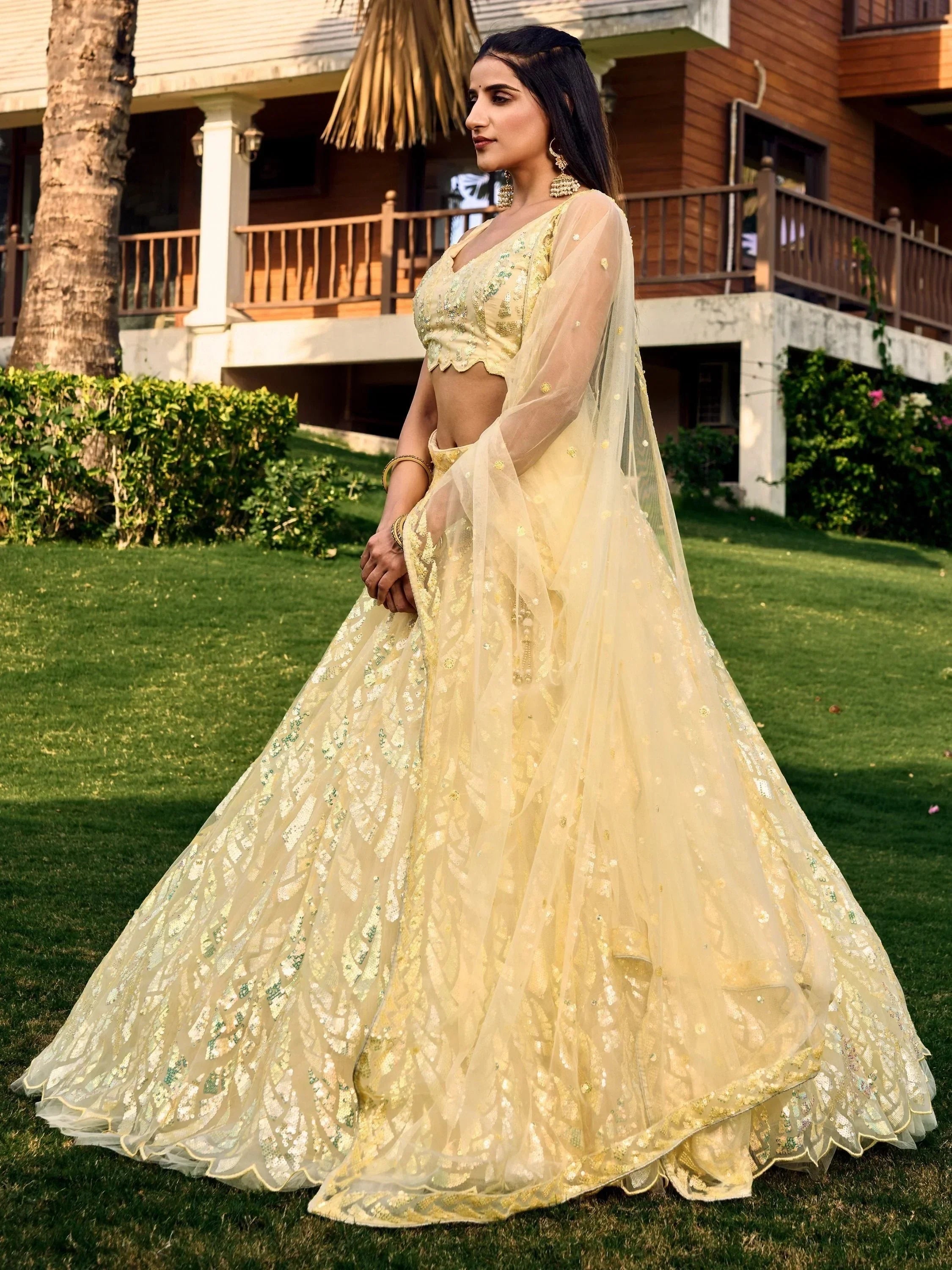 Elegant yellow designer lehenga choli with sequin work, perfect for Indian weddings and festive occasions.